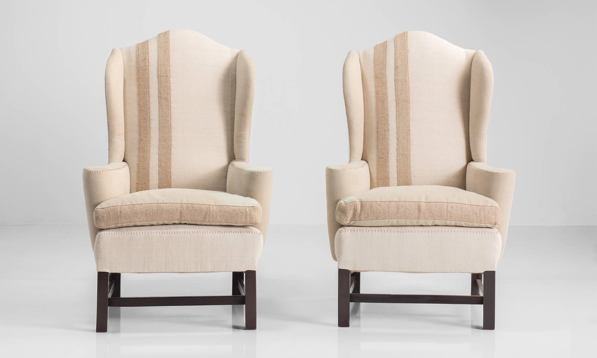 Pair of Upholstered Wingback Chairs, circa 1950

Classic form reupholstered in cotton with exposed stitching details. 