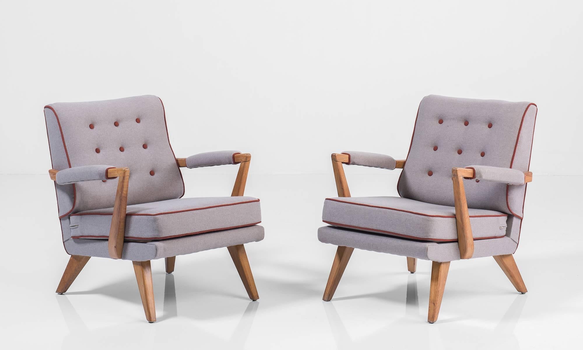 Upholstered modern oak armchairs, circa 1950.

With maroon piping. Elegant form with beautiful upholstery.