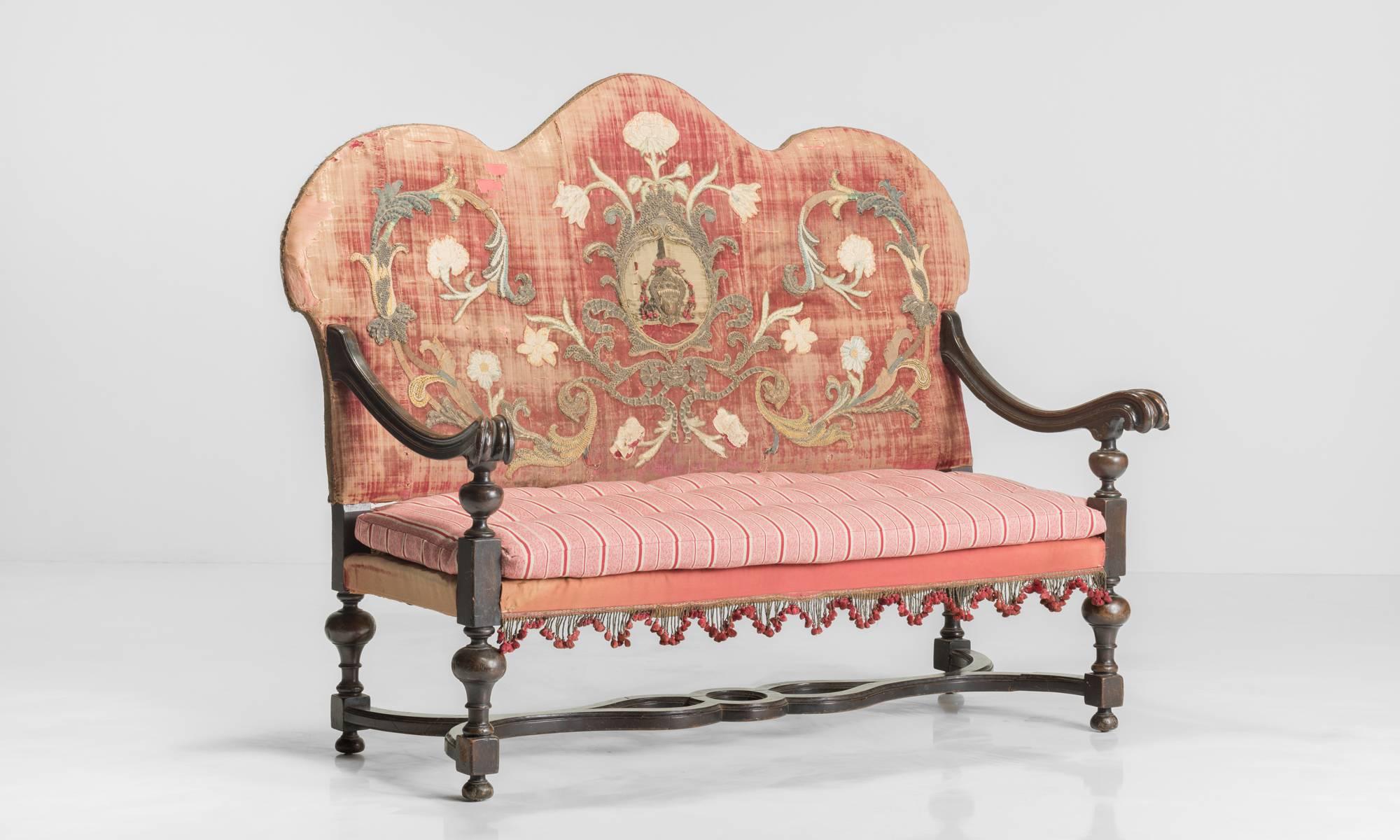 Embroidered velvet and oak Queen Anne camel back sofa, circa 1700.

With wonderfully carved oak frame. Original tattered velvet back with detailed embroidery consisting of wool, metallic threads, and silk.