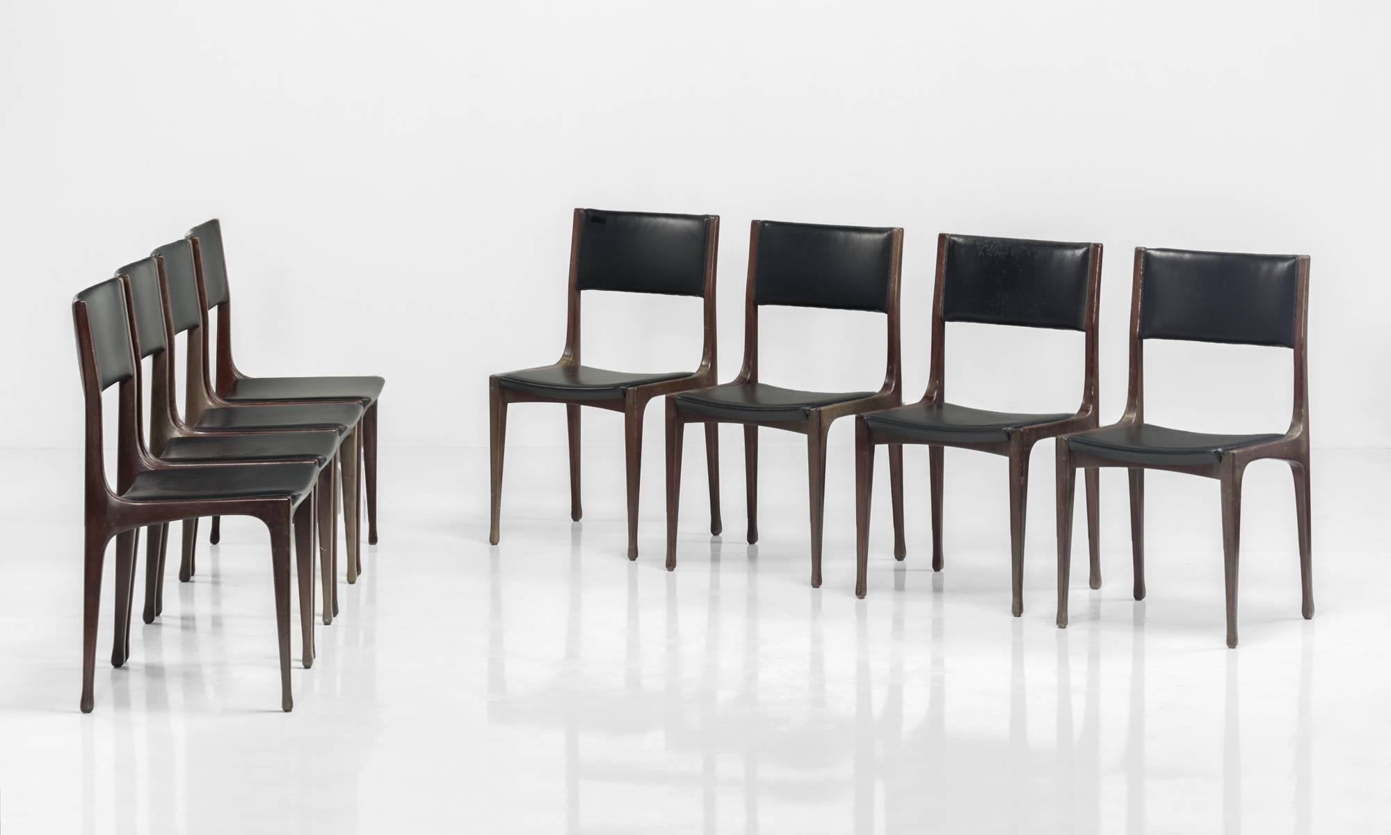 Model 693 Dining Chairs, designed by Carlo di Carli for Cassina. 

Original black vinyl upholstery on elegant wooden frame.