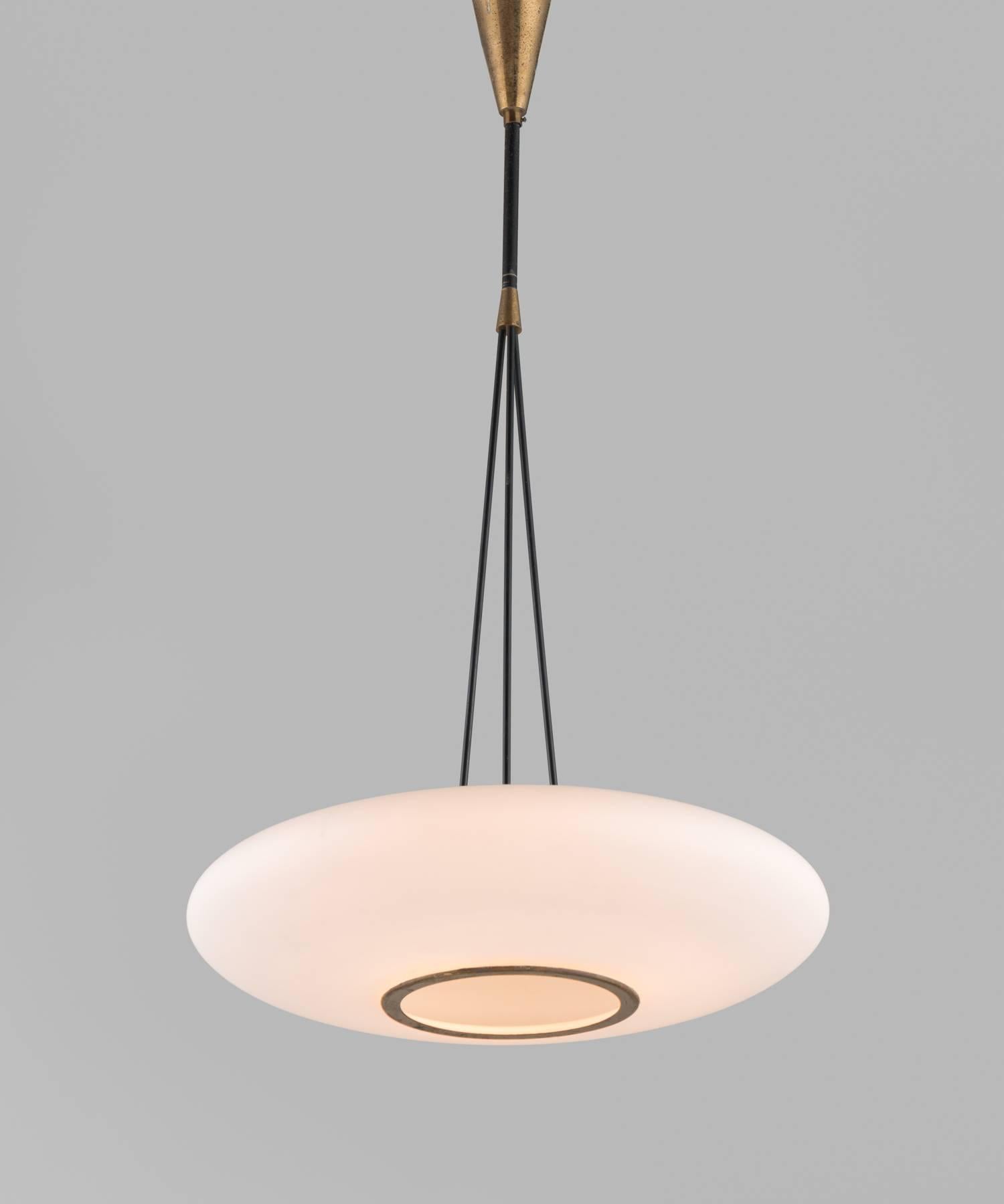 Opaline and brass suspension lamp by Stilnovo, circa 1950.

Sleek opaline glass shade with brass accents and canopy.