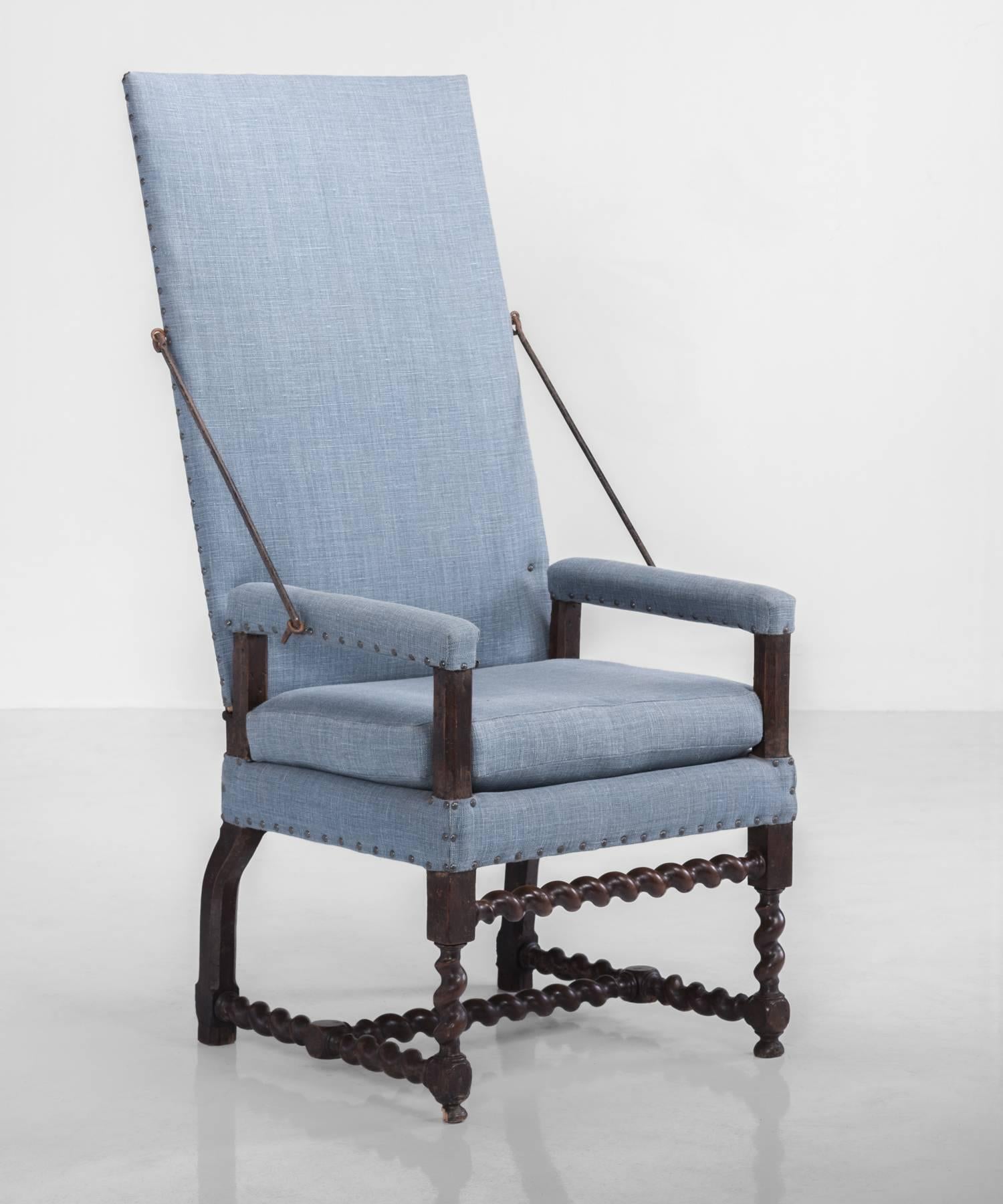 Primitive tallback chair, France, circa 1710.

Includes original iron hardware and beautifully turned legs and stretchers. Restored and newly reupholstered including contrasting fabric on back.