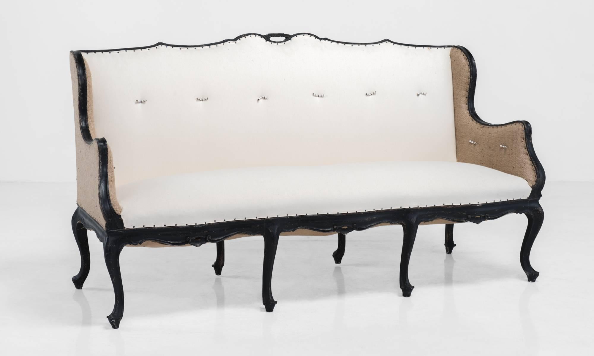 Italian ebonized wood sofa, circa 1900.

Elegant ebonized frame and legs. Reupholstered with contrasting cotton and burlap.