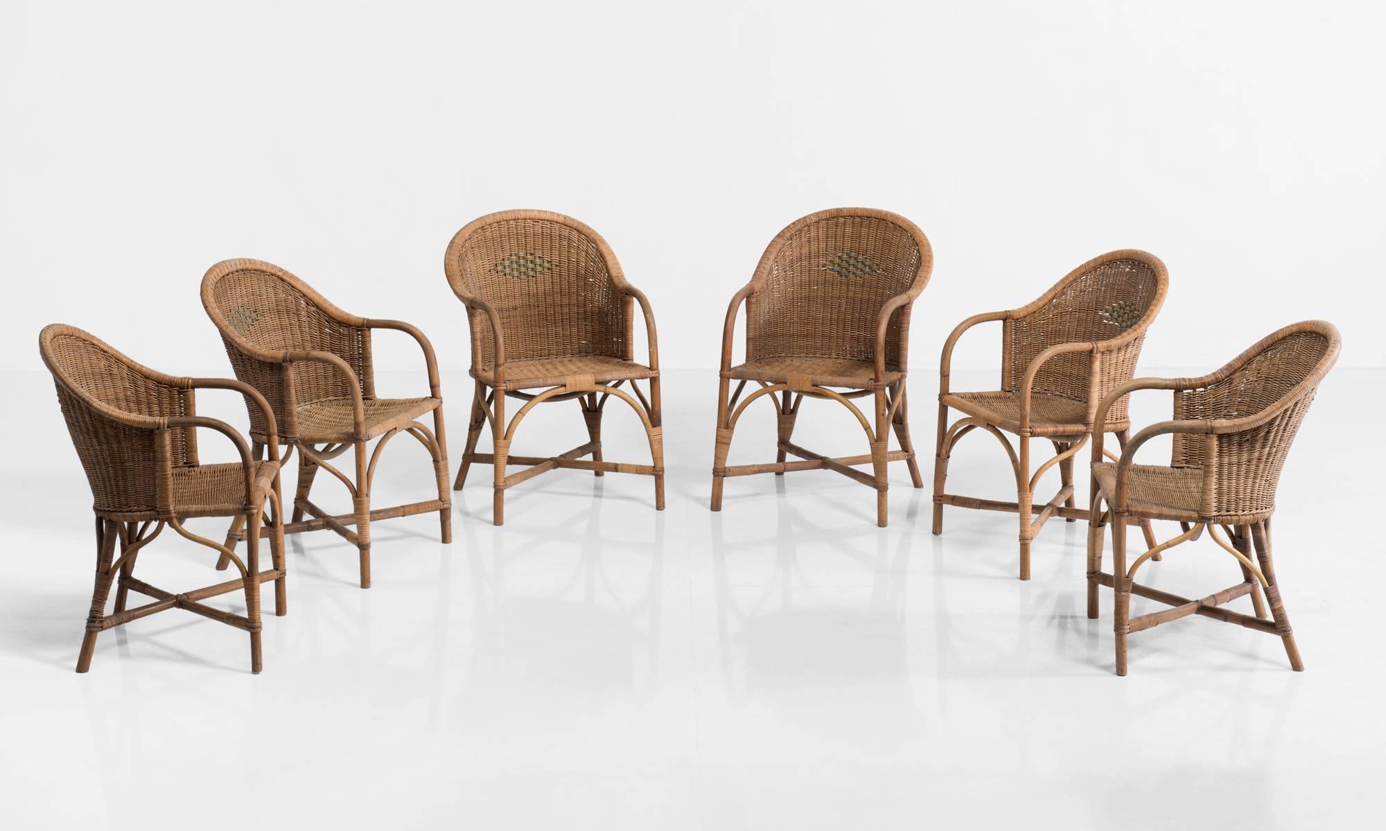 Wicker garden armchairs, circa 1910.

Woven armchairs made by Dryad, and retailed through Heals of London. All in original condition.