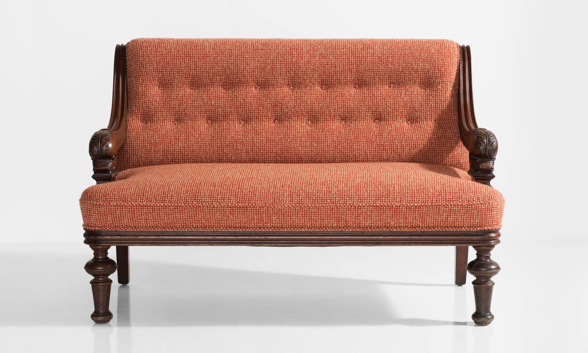 Curious Mahogany Napoleon & Wool Napoleon sofa, France, circa 1890.

Carved armrests with dolphin head motif, newly upholstered in Maharam wool fabric.