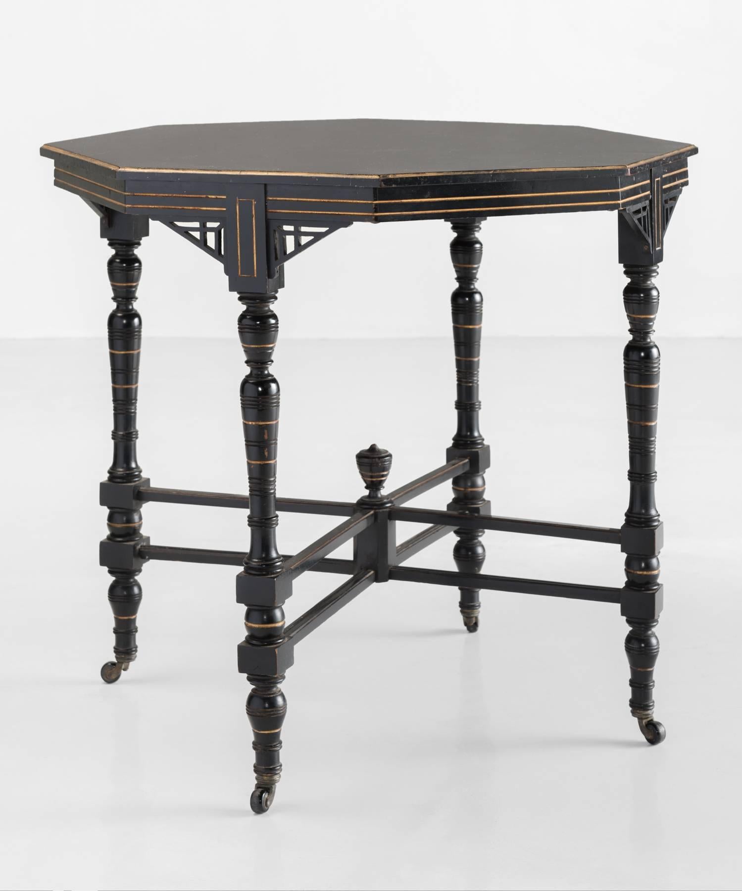 Aesthetic Movement ornate side table, circa 1880.

Ebonized table with gilded detailing on original castors.