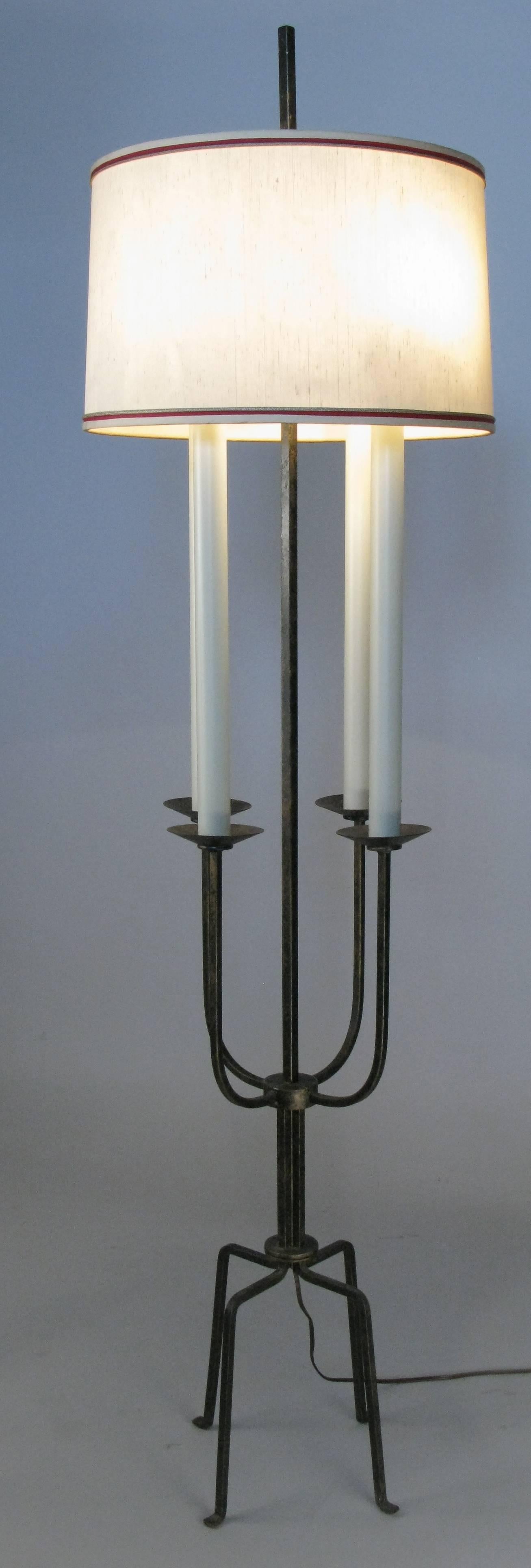 A classic modern 1940s wrought iron floor lamp by Tommi Parzinger for Parzinger originals. Beautiful design with four 'candle' lights and the original shade. In its original black with gold wash finish.