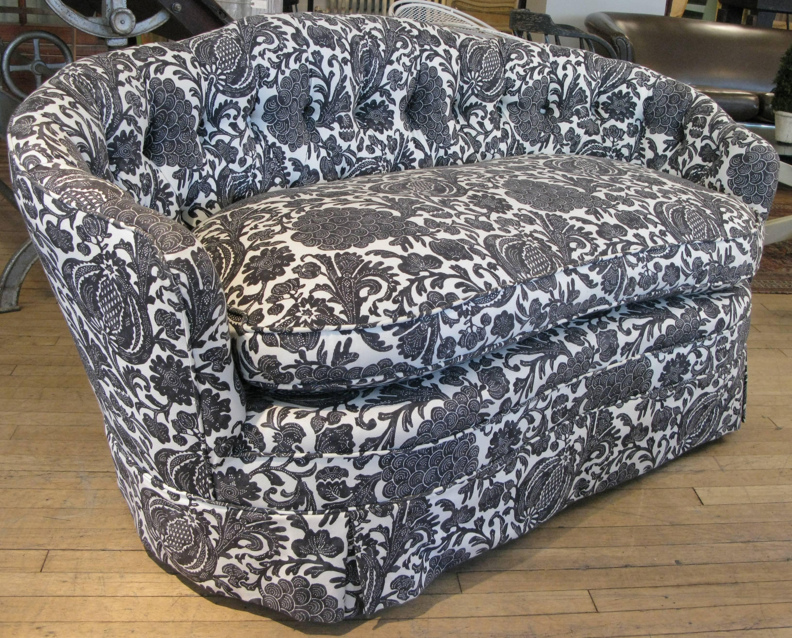 A very nice curved back settee with fully button tufted back and a large down seat cushion. in its original black and white patterned fabric, all in excellent condition.