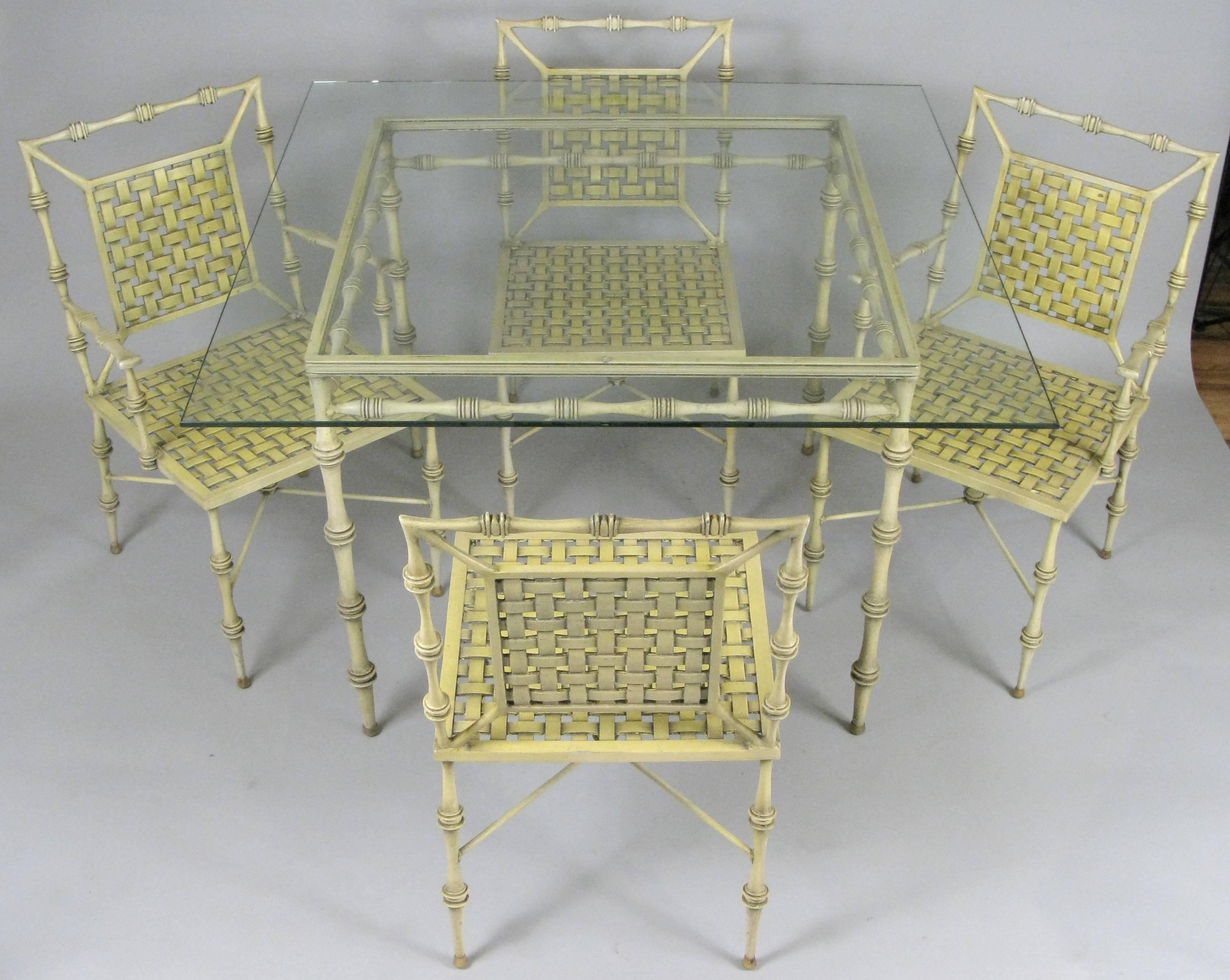 A very charming and elegant vintage 1960s aluminum dining set by Phyllis Morris, with a glass top sqaure table and a pair of armchairs and a pair of side chairs. All in their original finish which is a pale yellow with dark beige in the rececsses of