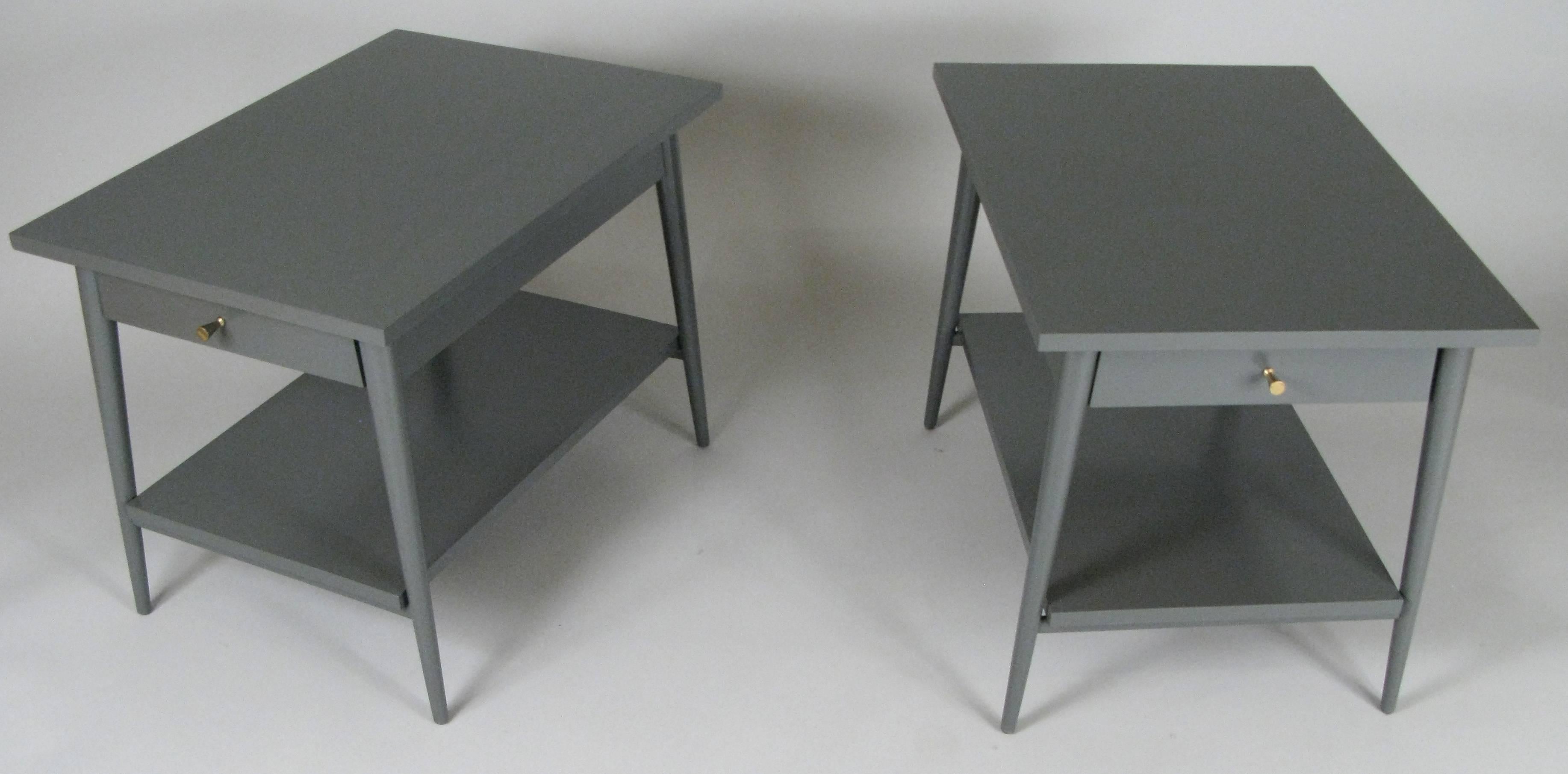 A very handsome pair of vintage 1950s birch nightstands designed by Paul McCobb from his Planner Group series, lacquered in a very nice dark grey color called 'Iron Mountain'. With a single drawer each with McCobb's signature brass cone drawer pull