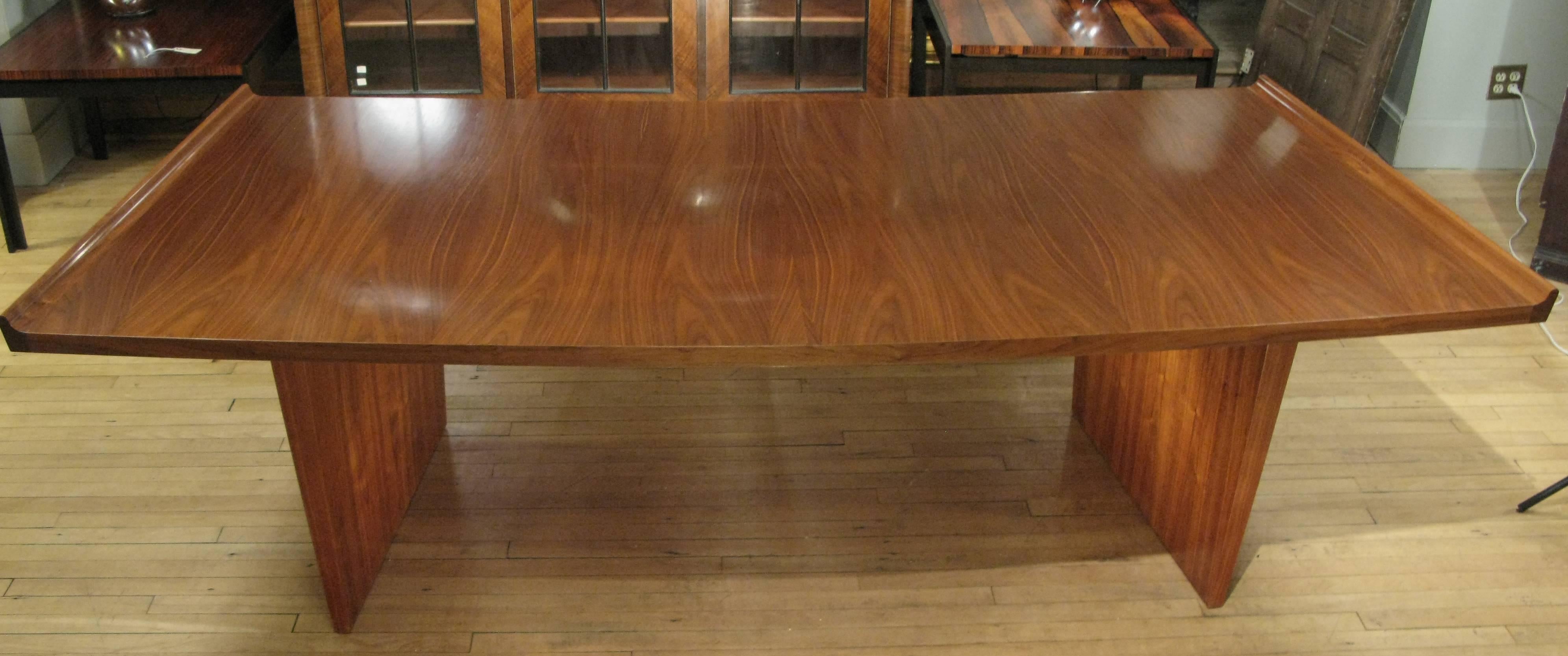 A beautiful vintage 1950s curved walnut executive desk by Harvey Probber, with a beautiful large curved top and tapered bases, with very nice details including raised edges on both sides and a pair of slim drawers. Beautifully restored.