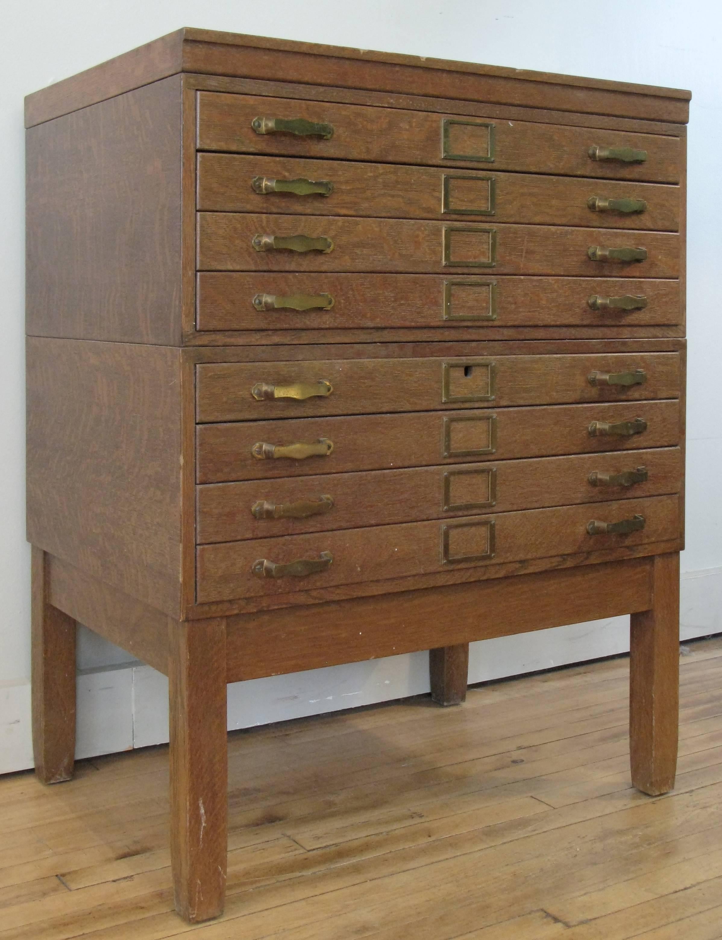 A very handsome antique 1940s oak architects flat file or map case, raised on square legs, the two part case has eight full width drawers with interior brass retaining bars for keeping the contents of the drawer from catching on the drawer frame.
