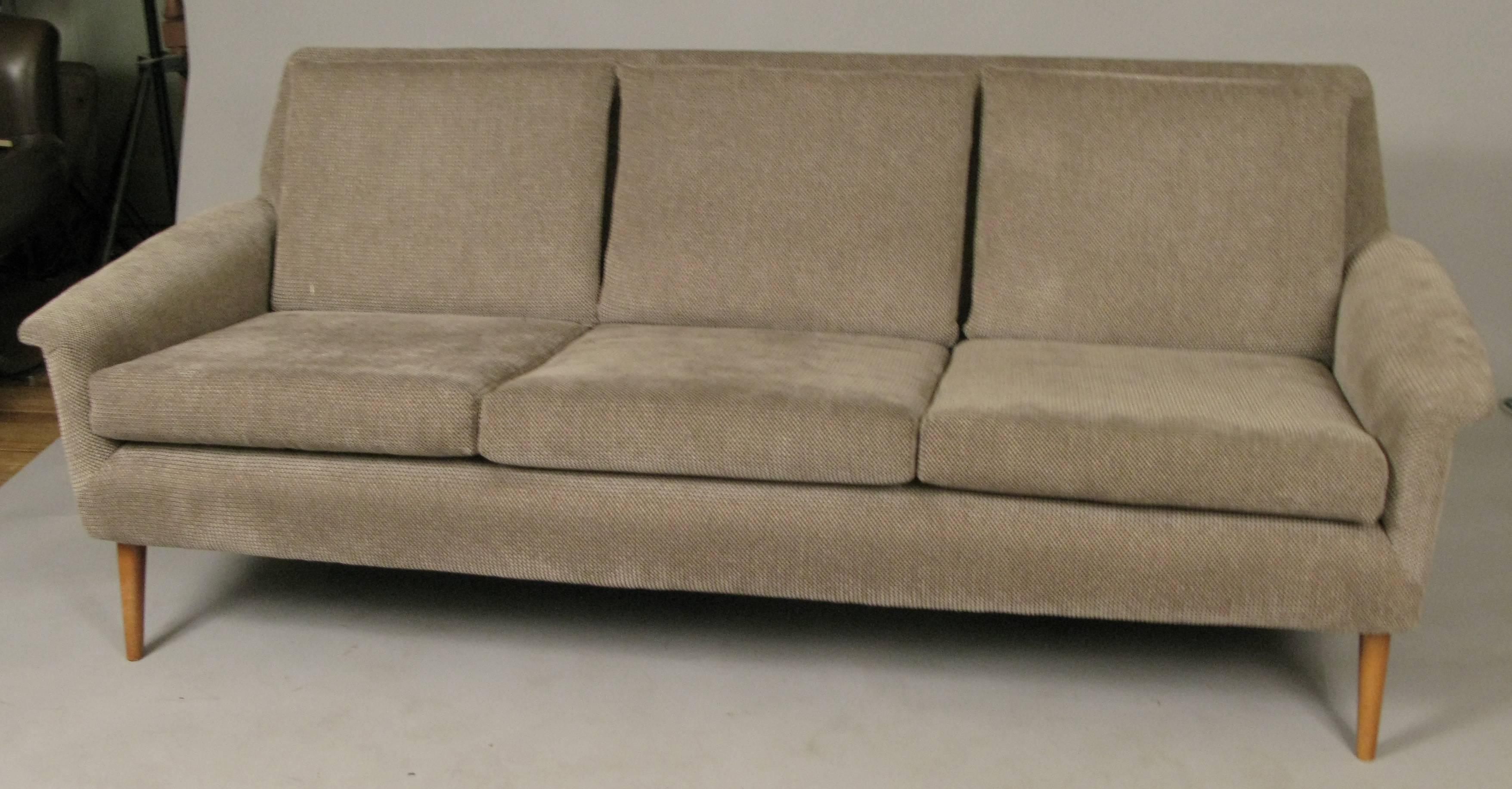 A beautiful vintage 1960s three-seat sofa designed by Folke Ohlsson for DUX, with solid birch frame and legs, and subtle wing arms, upholstered in a soft and comfortable woven fabric.