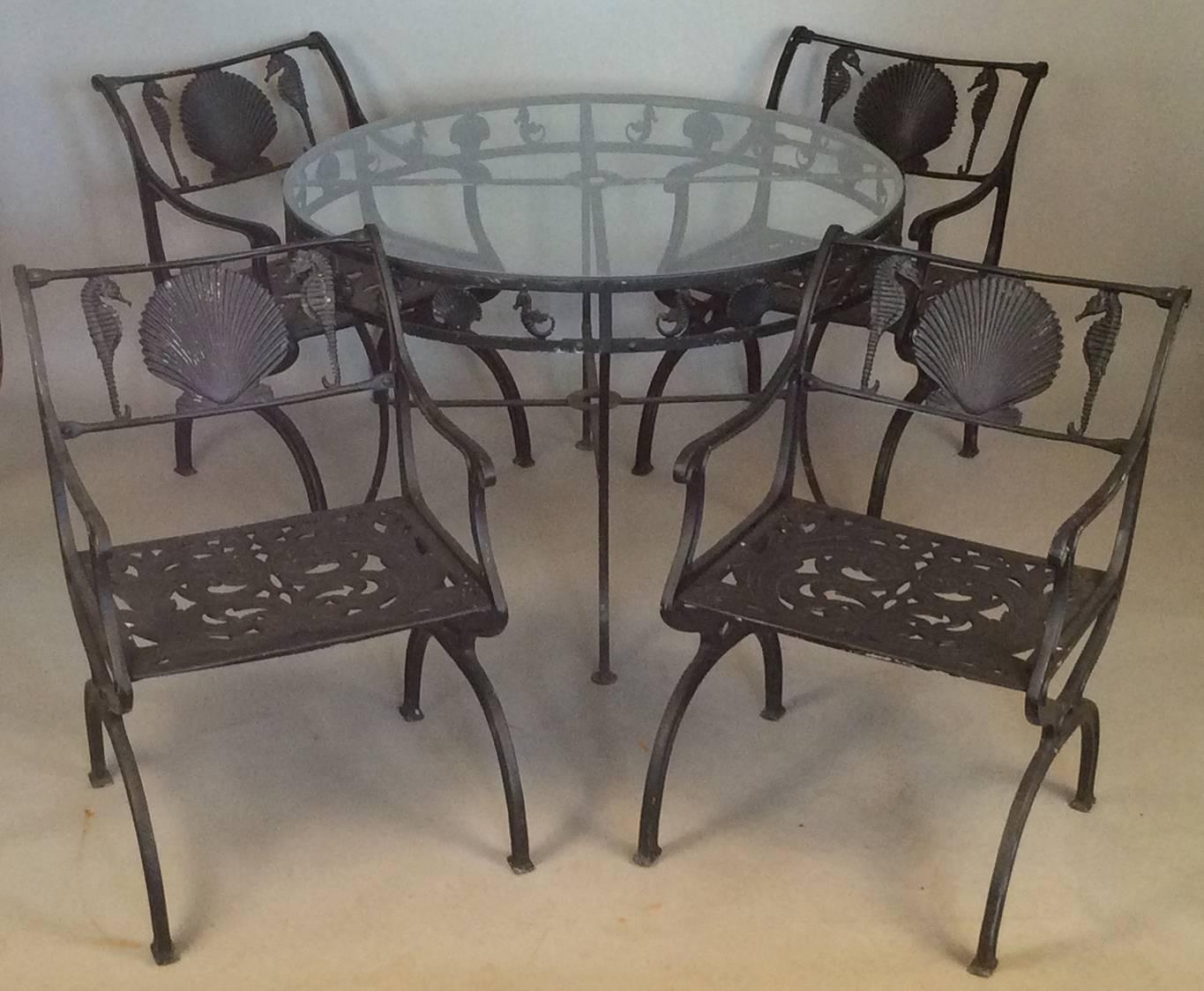 A wonderful vintage 1950s outdoor dining set designed by Molla and made in heavy cast aluminum, with their iconic seashell and seahorse motif. 

The famous Preakers hotel in Palm Beach was just one of several hey-day hotels around the country