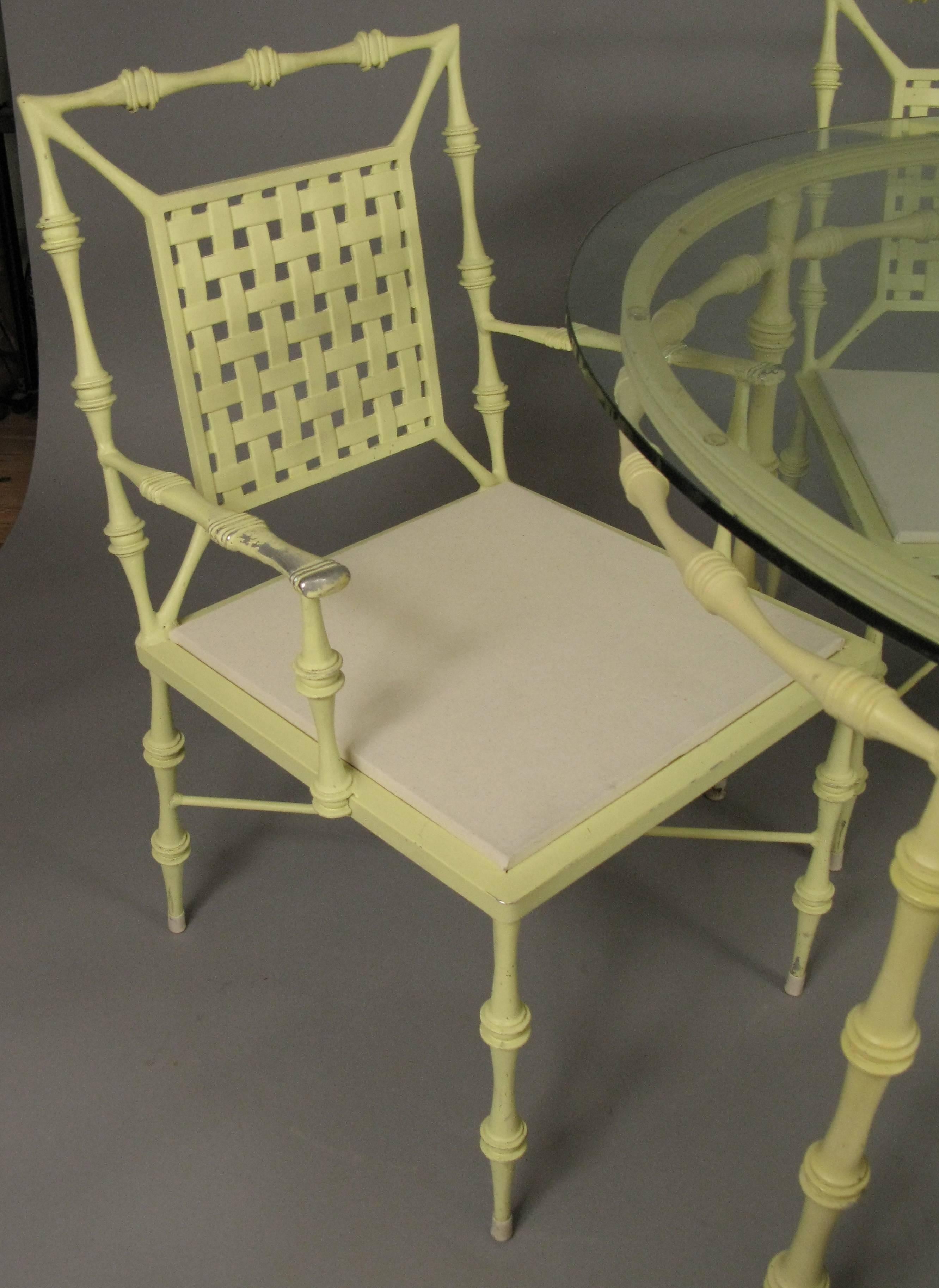 A very charming and elegant vintage 1960s aluminium dining set by Phyllis Morris, with a glass top round table and four chairs, including an armchair. All in their original yellow finish, in good condition with light wear overall.

Measures: Chair