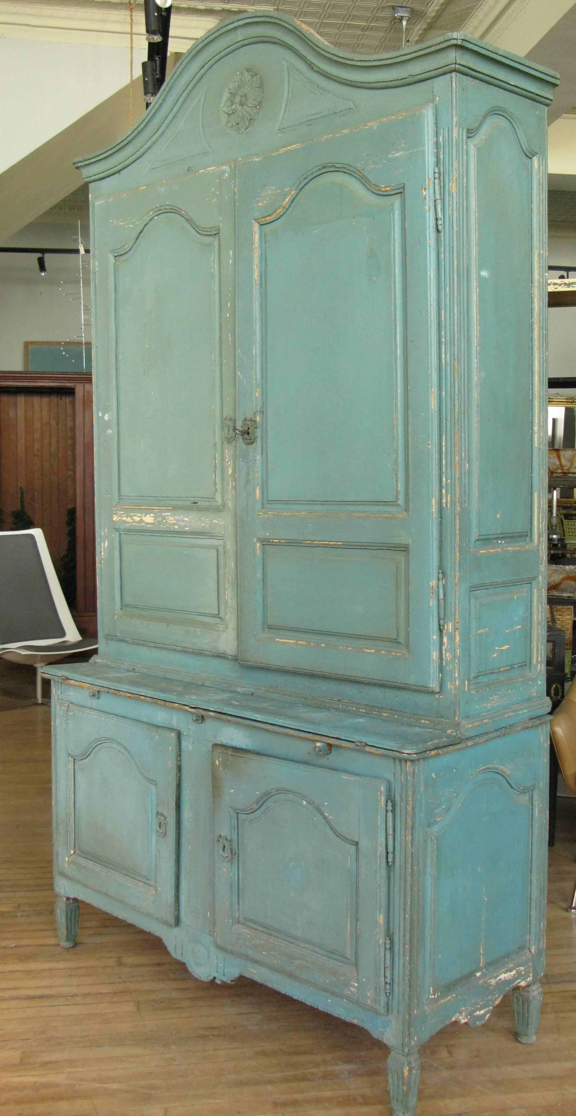 A very charming antique late 19th century cupboard in its original blue/green painted finish. The upper interior fitted with cubbies, and with its original cast iron lock and key. The lower portion with a shelf and a small fold-out desk surface. The