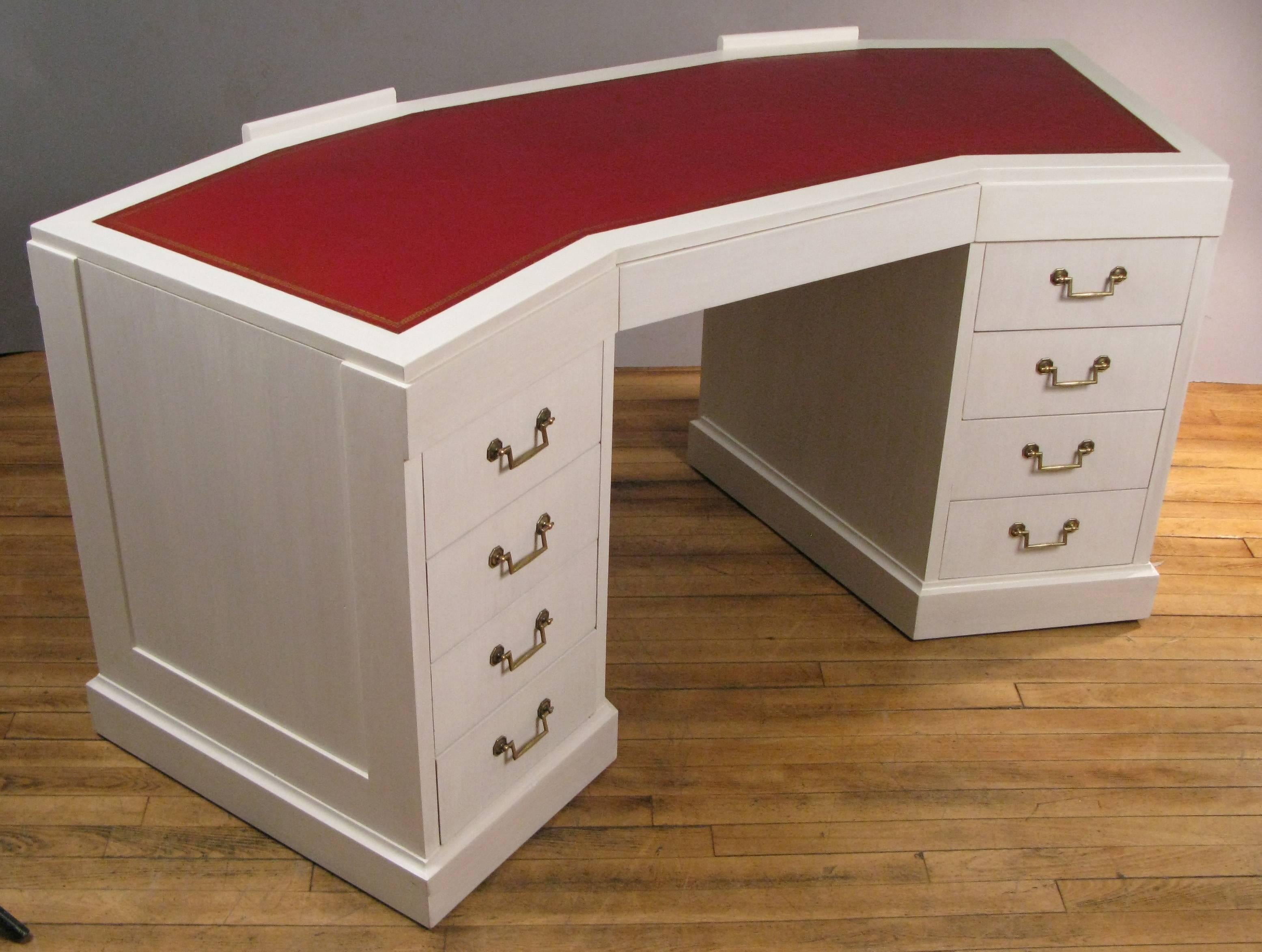 A rare vintage 1940s wing shaped desk with original leather top by Grosfeld House. Beautiful design with angled drawers and solid brass hardware. The back side having a small inset bookcase in each side with an adjustable shelf. The case refinished