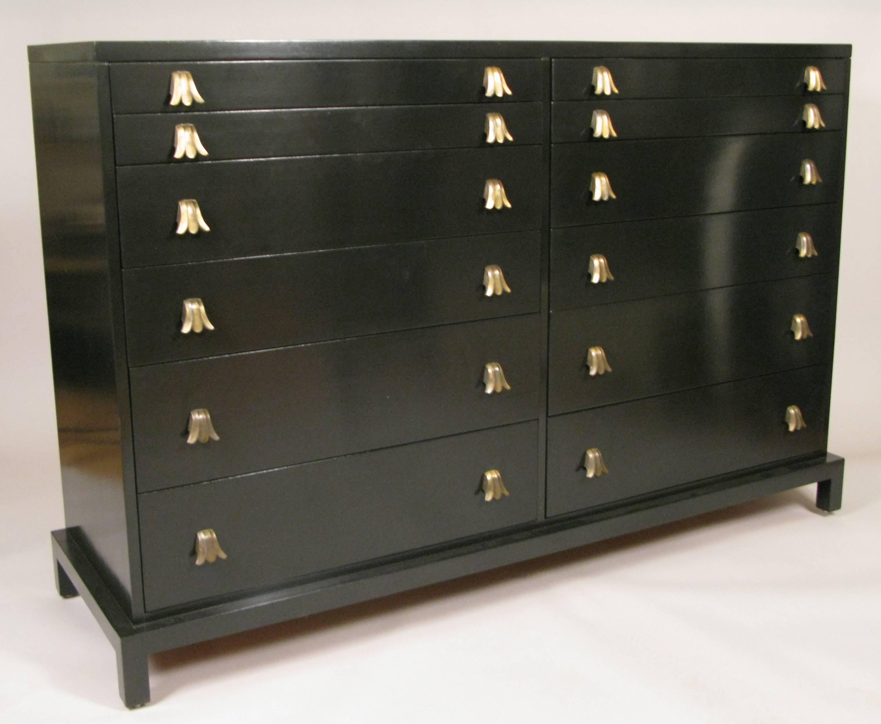A stunning rare vintage 1950s 12-drawer double chest by Widdicomb. Beautiful design and cabinetwork, with two rows of graduated drawers, several divided and flared drawer pulls in original finish. The case has a gorgeous ebonized finish.