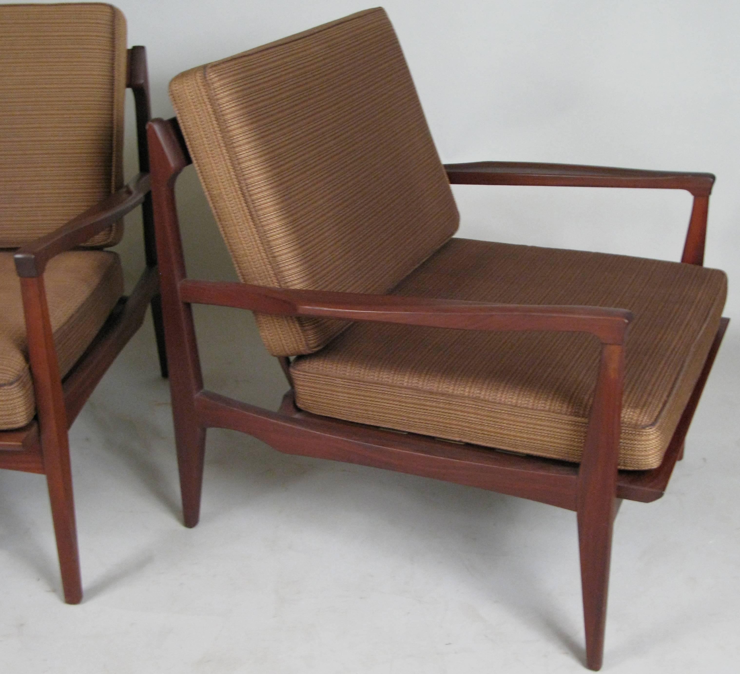 A pair of very handsome and well made 1950s teak lounge chairs made in Norway, with dark finished frames and beautiful details. Original upholstery on the cushions is in good condition with age expected wear.