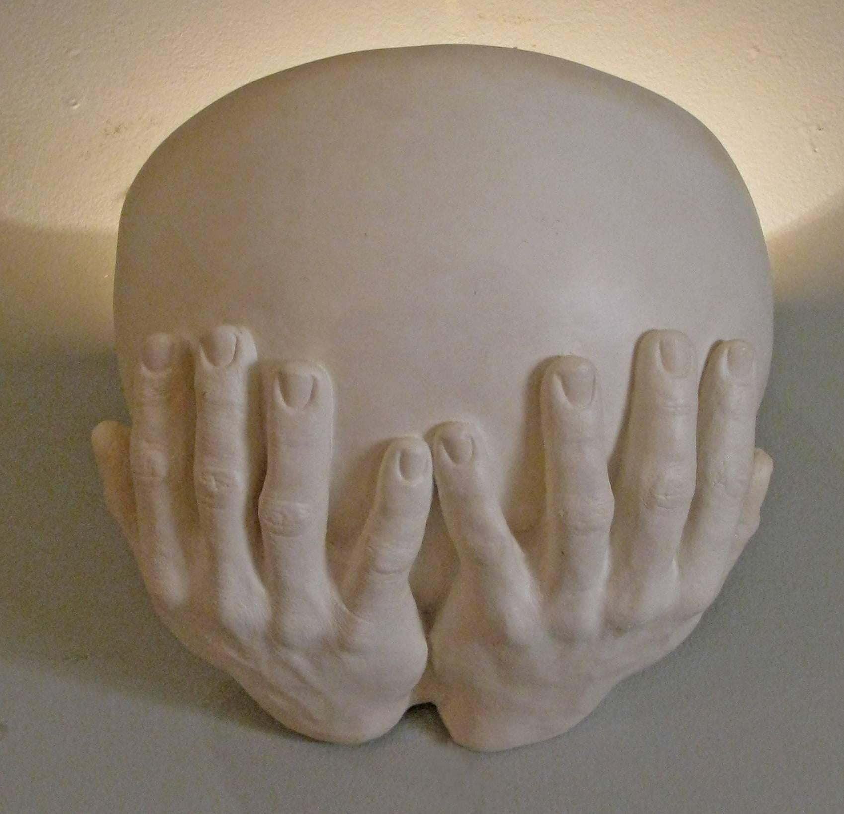 A pair of beautiful plaster sconces made by artist Richard Etts, from his iconic 'Hands' series. Each has a pair hands holding a half bowl with a single light socket in each. Both are signed and dated 'Richard Etts 1976'.