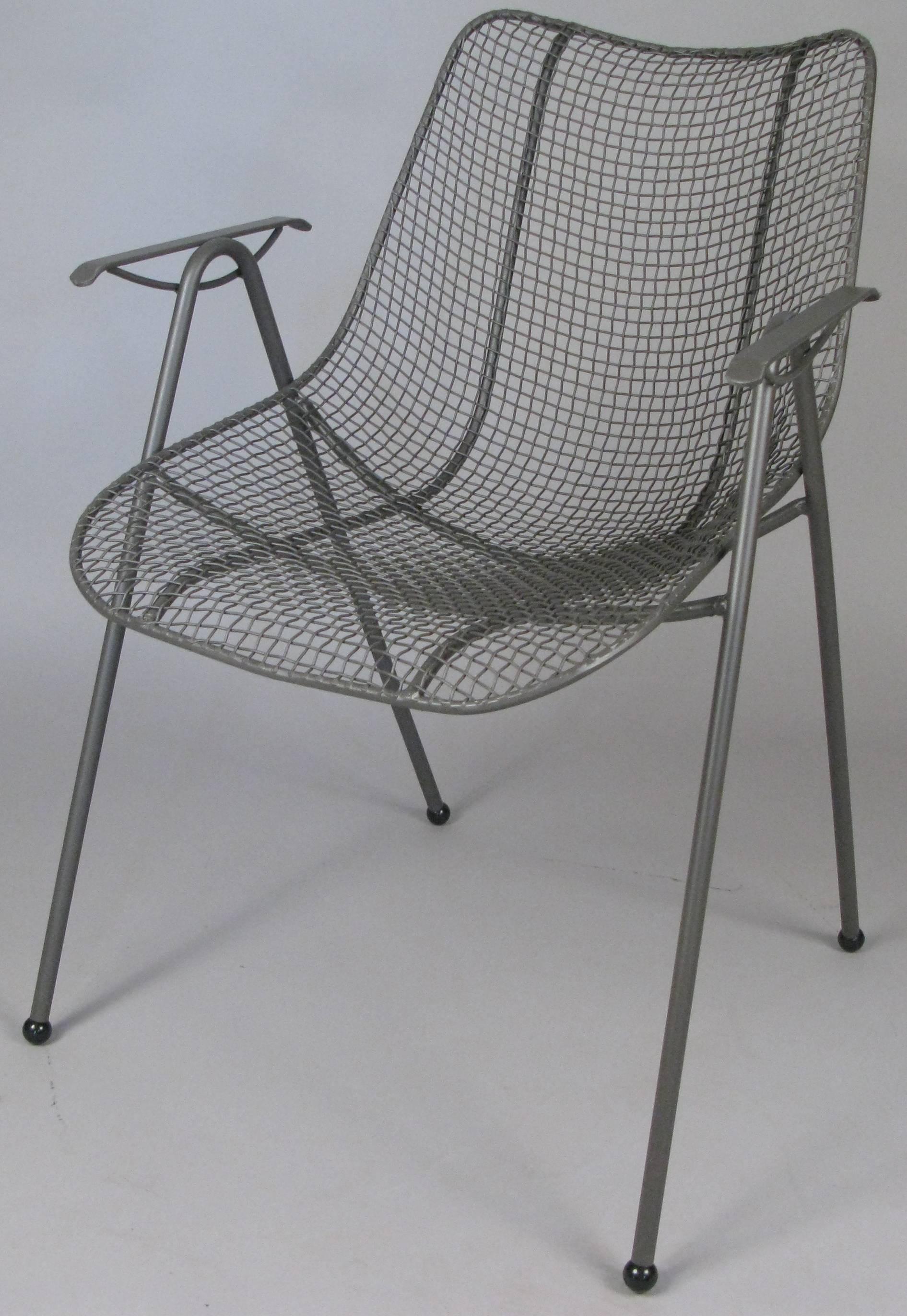 A matched set of eight 1950s wrought iron dining chairs from Russell Woodard's Sculptura collection. With Woodard's signature woven steel mesh seats, all chairs refinished in greige.