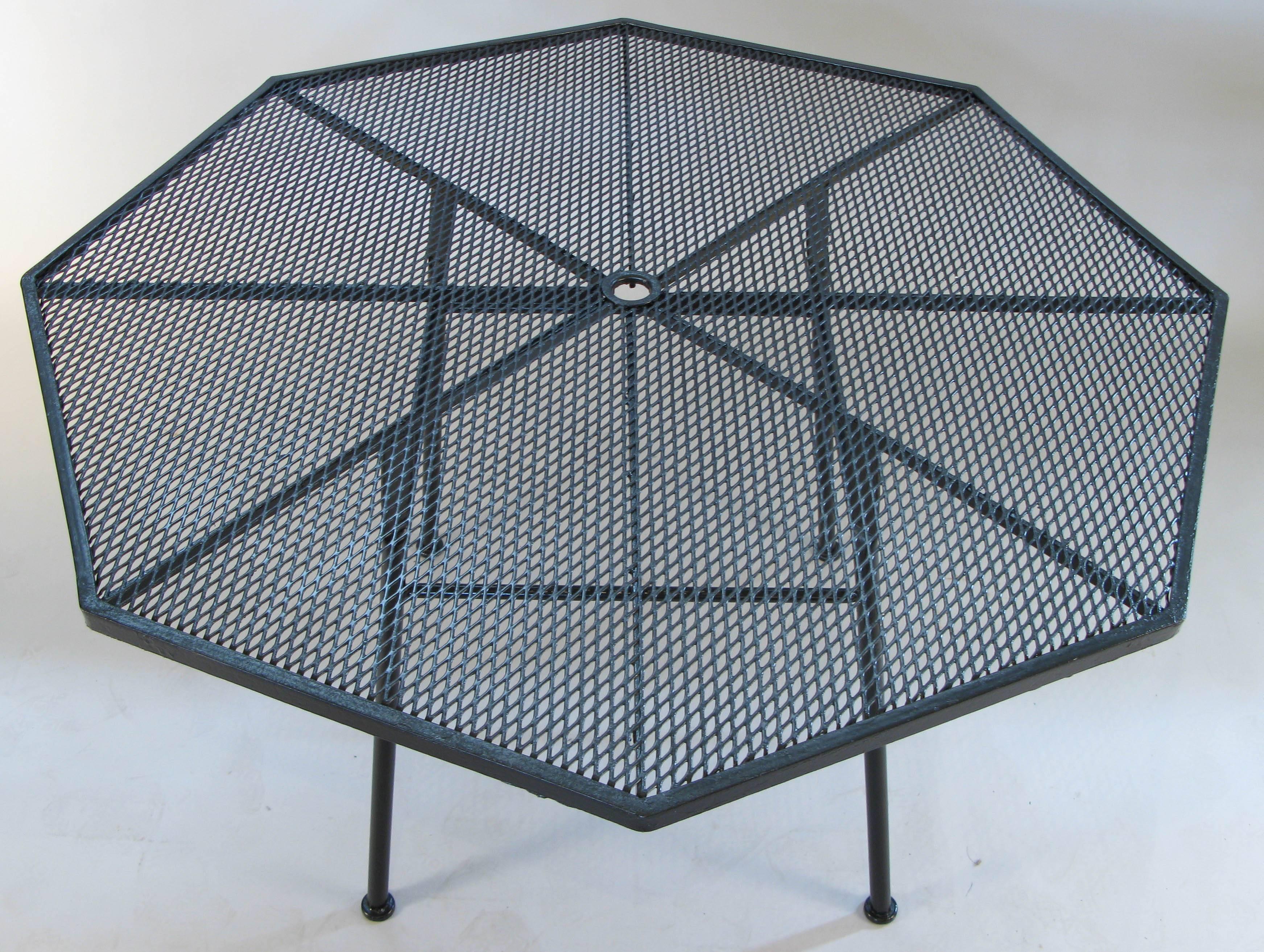 A 1950s octagonal dining table by Russell Woodard in wrought iron and steel mesh from his 1950s Sculptura collection. recently refinished in Greige. we also have sets of Sculptura dining chairs in separate listings.
