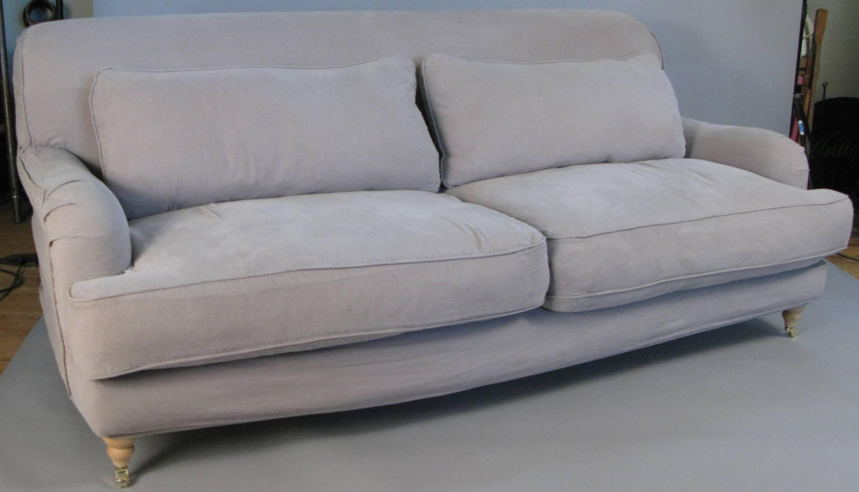 A very well made and stylish rolled arm Portobello sofa by Rachel Ashwell. The frame is upholstered in muslin, and includes two sets of slipcovers, one in grey linen, and the other set is in white denim. Cushions are down.