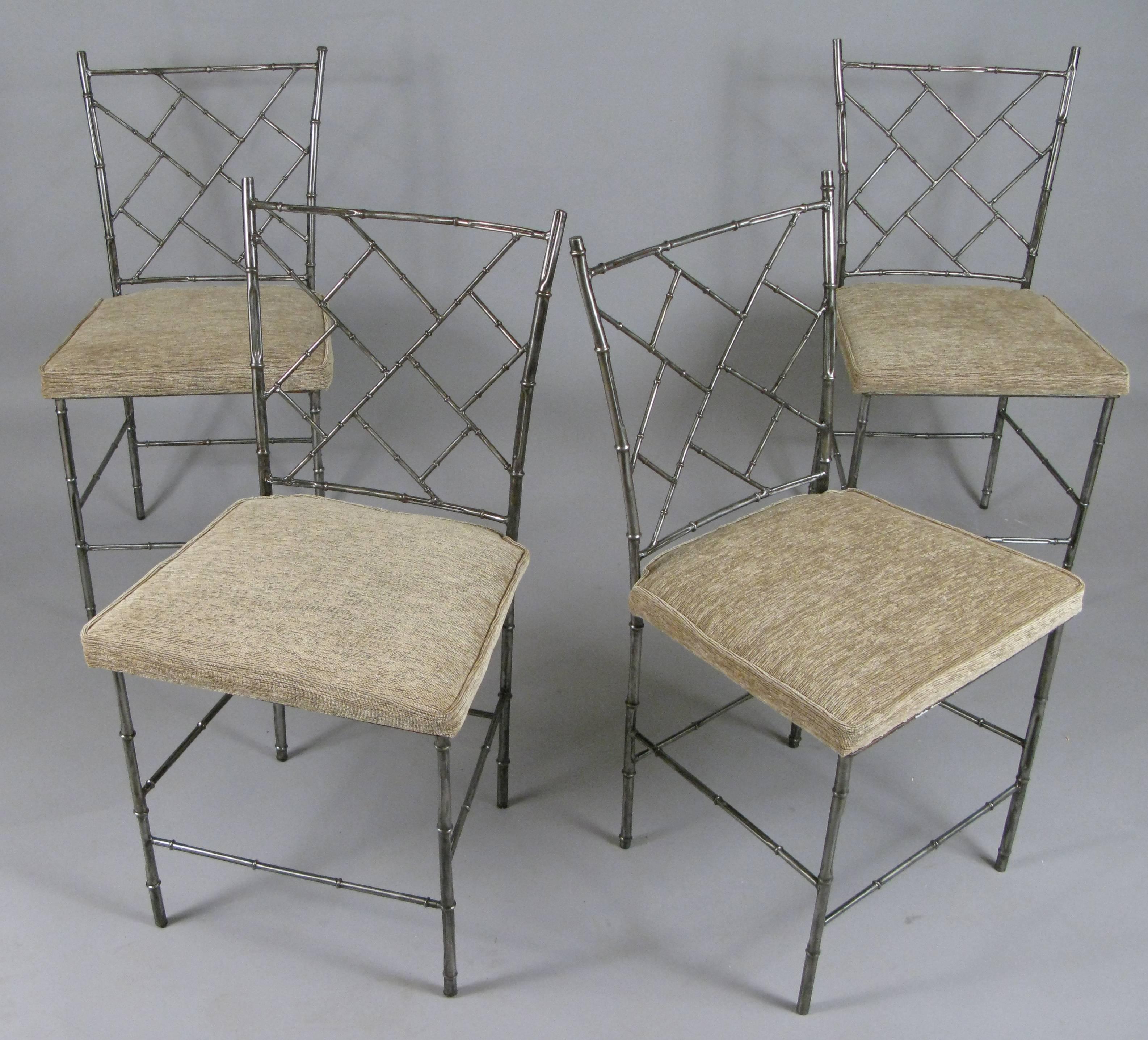 a set of vintage 1960's steel frame dining chairs, with a bamboo pattern in the frames, and chippendale motif in the seatback. stripped of old painted finish, and with newly upholstered seats in a woven chenille. 