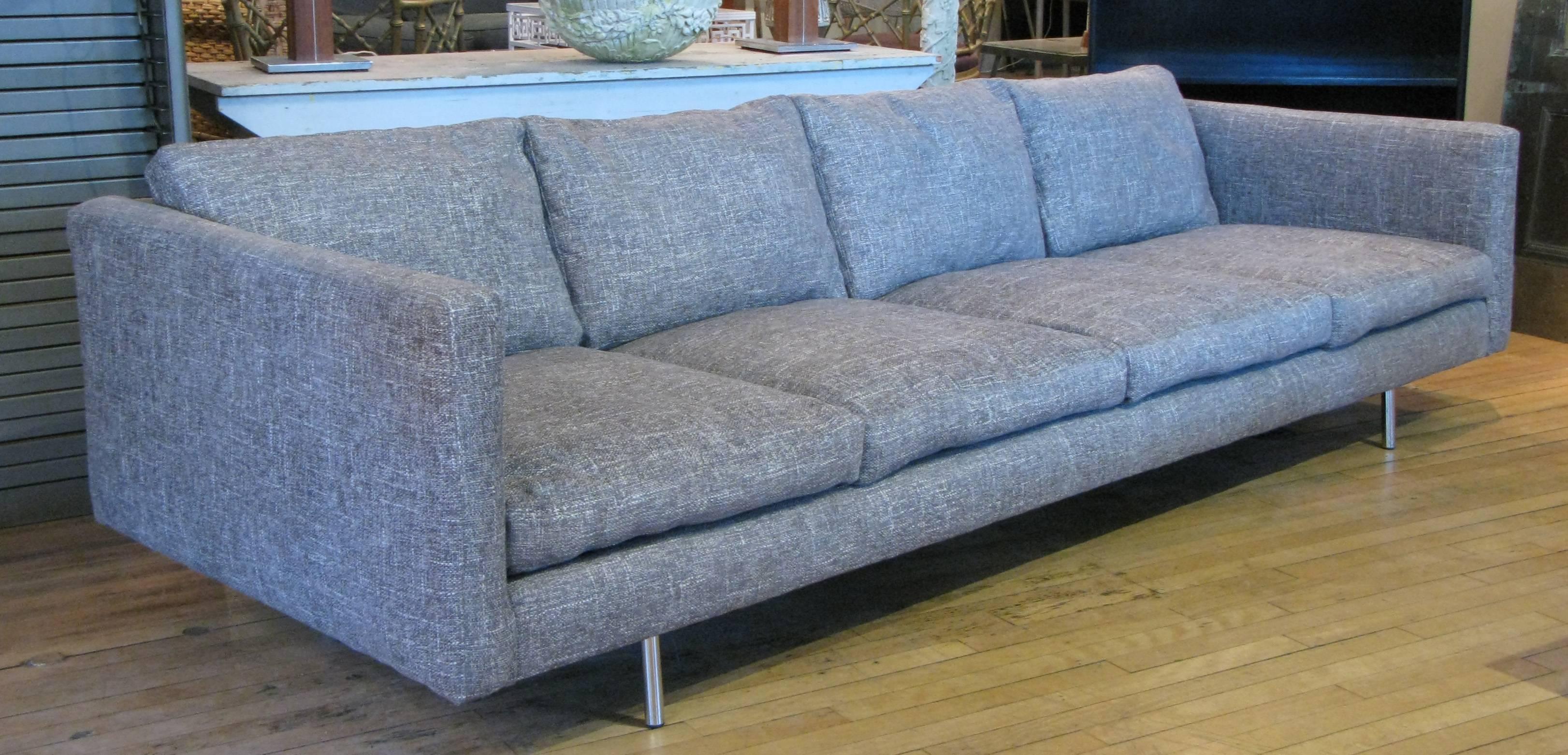 A very nice 1950s long four seat tuxedo sofa, with chrome legs. Reupholstered in a grey and cream woven textured fabric.