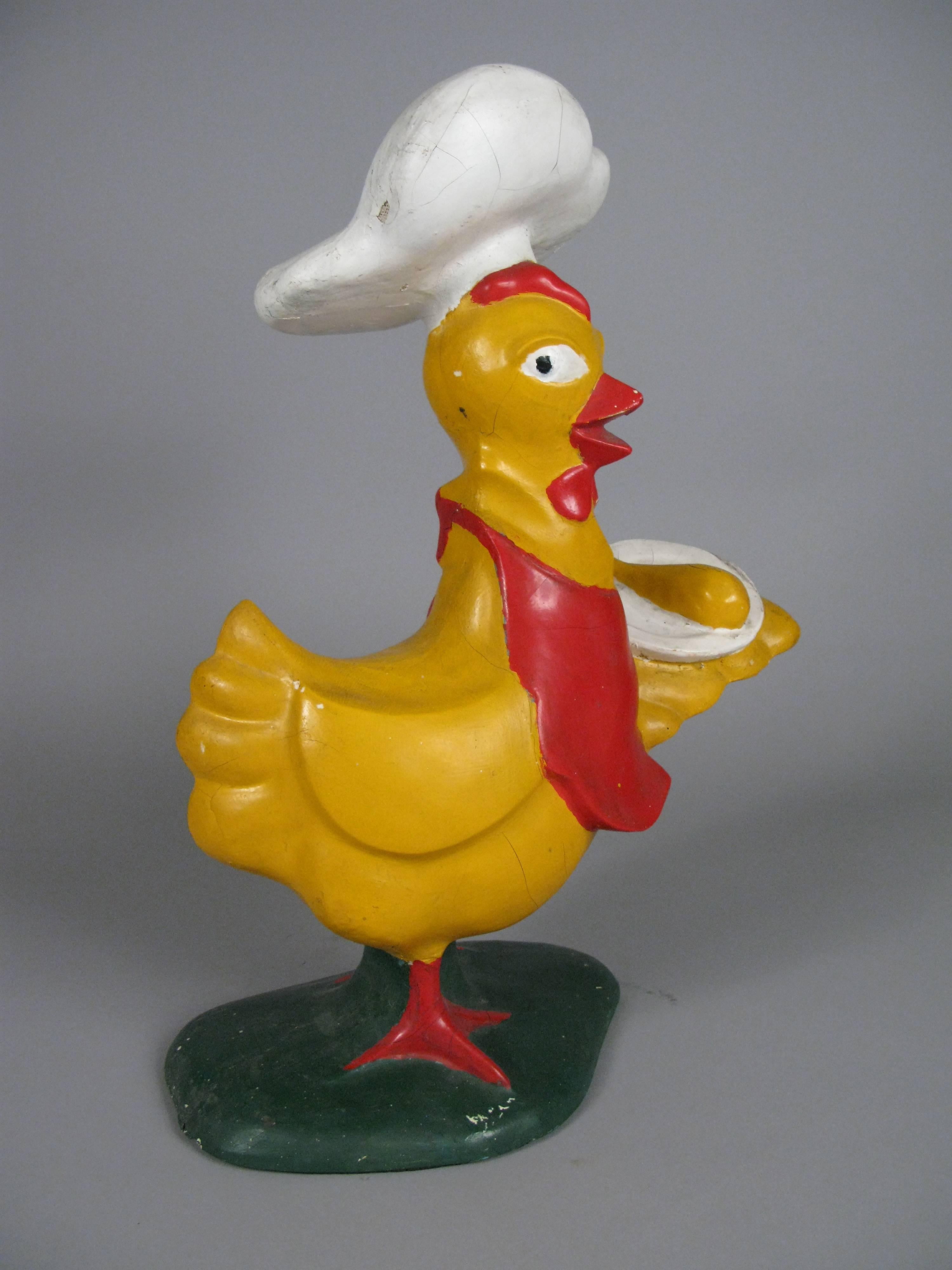 A charming 1960s fiberglass and handpainted Chef Hen serving chicken on a platter. very unique, likely an advertising prop. in as found original condition, with cracks to the surface as shown. 