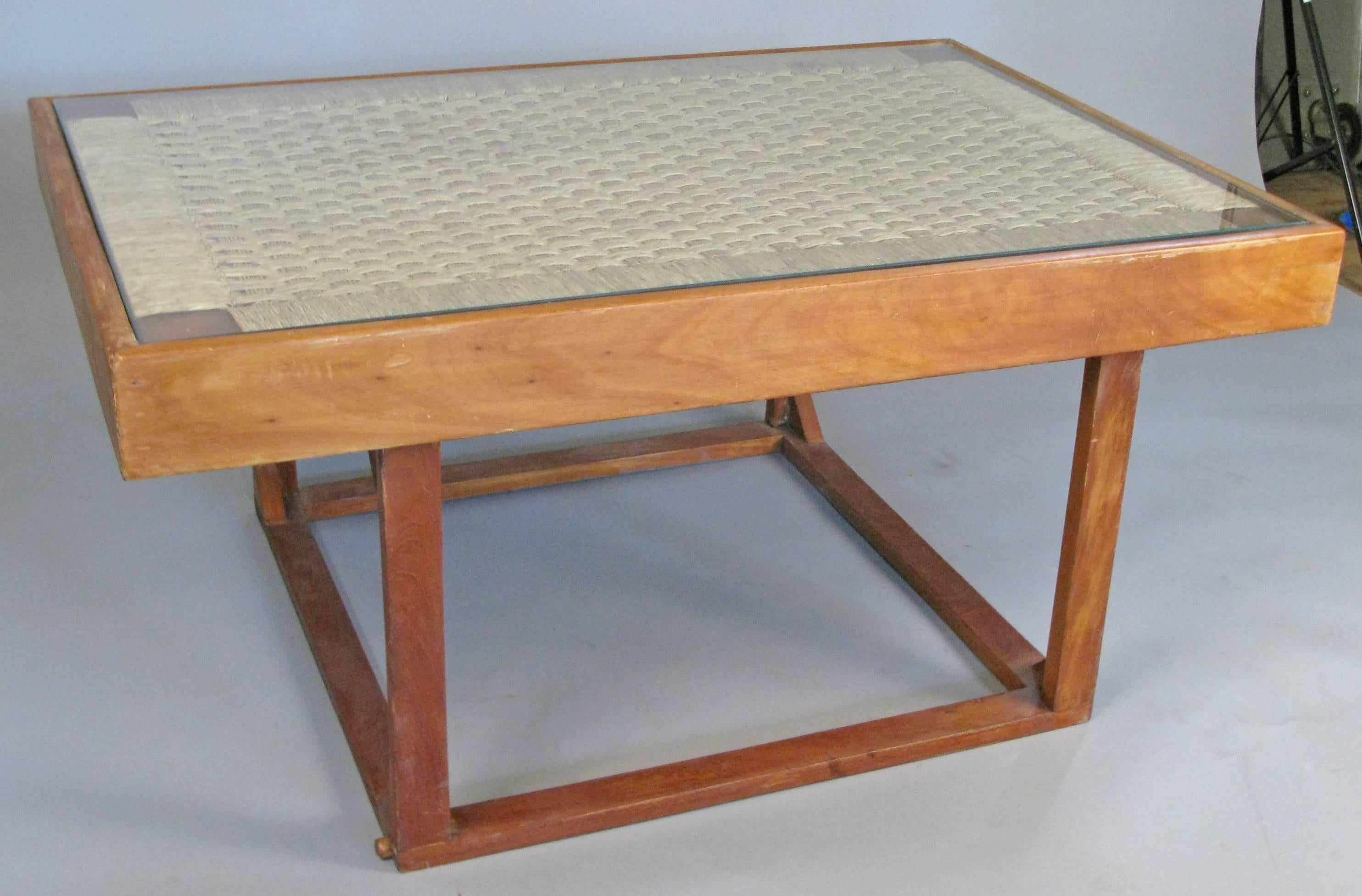 A beautiful and very unique oak base table from the 1950's, that converts from a low cocktail table to a higher console height table by attaching the base in two different configurations. has a very nice top with woven cord and a glass top. the