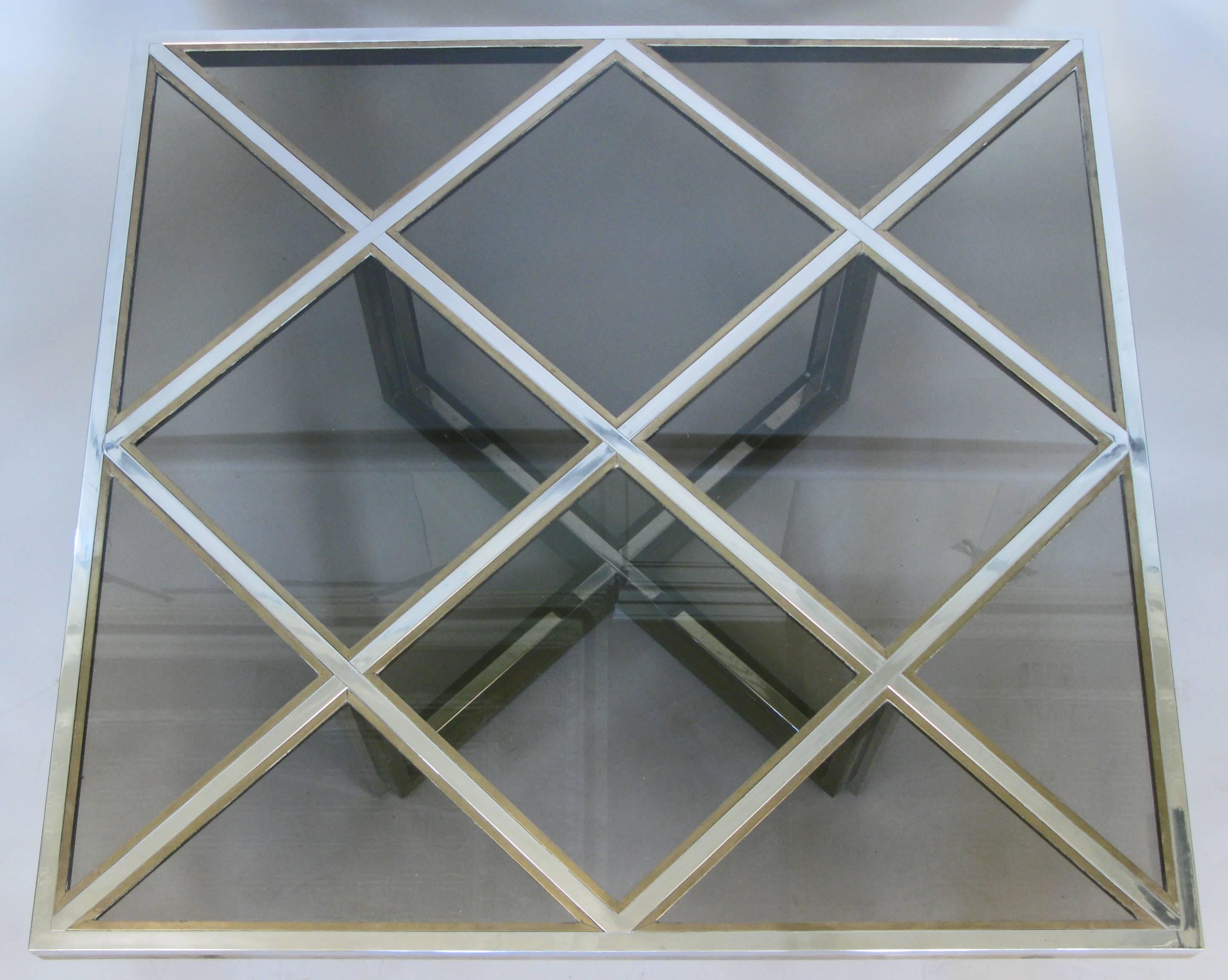 A stunning vintage 1970s large square cocktail table in brass and chrome with smoked glass panels by Romeo Rega. Fantastic design and scale.