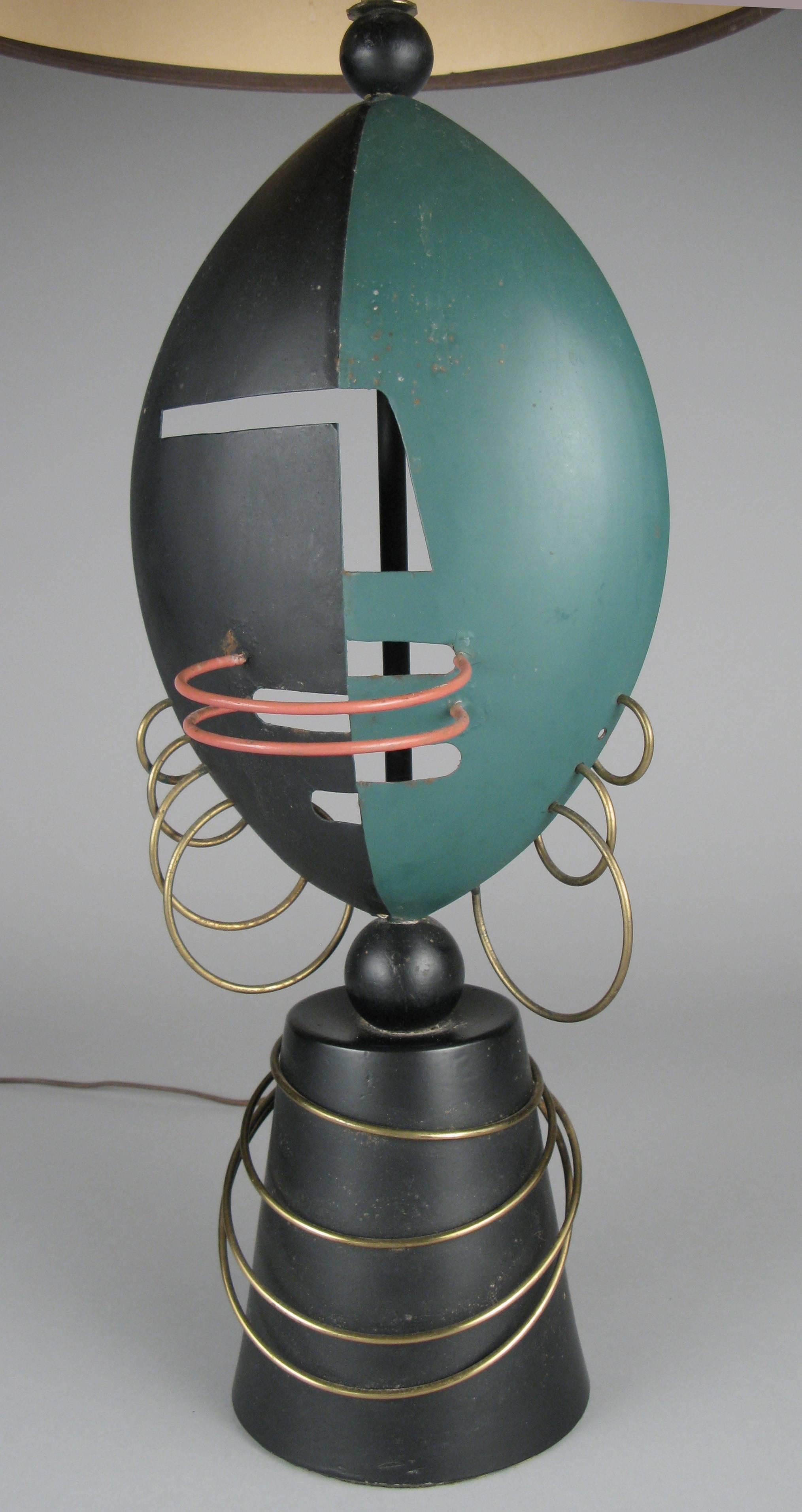 A very unique and interesting vintage 1950s table lamp, made in the form of a modern cubist interpretation of an African tribal mask.