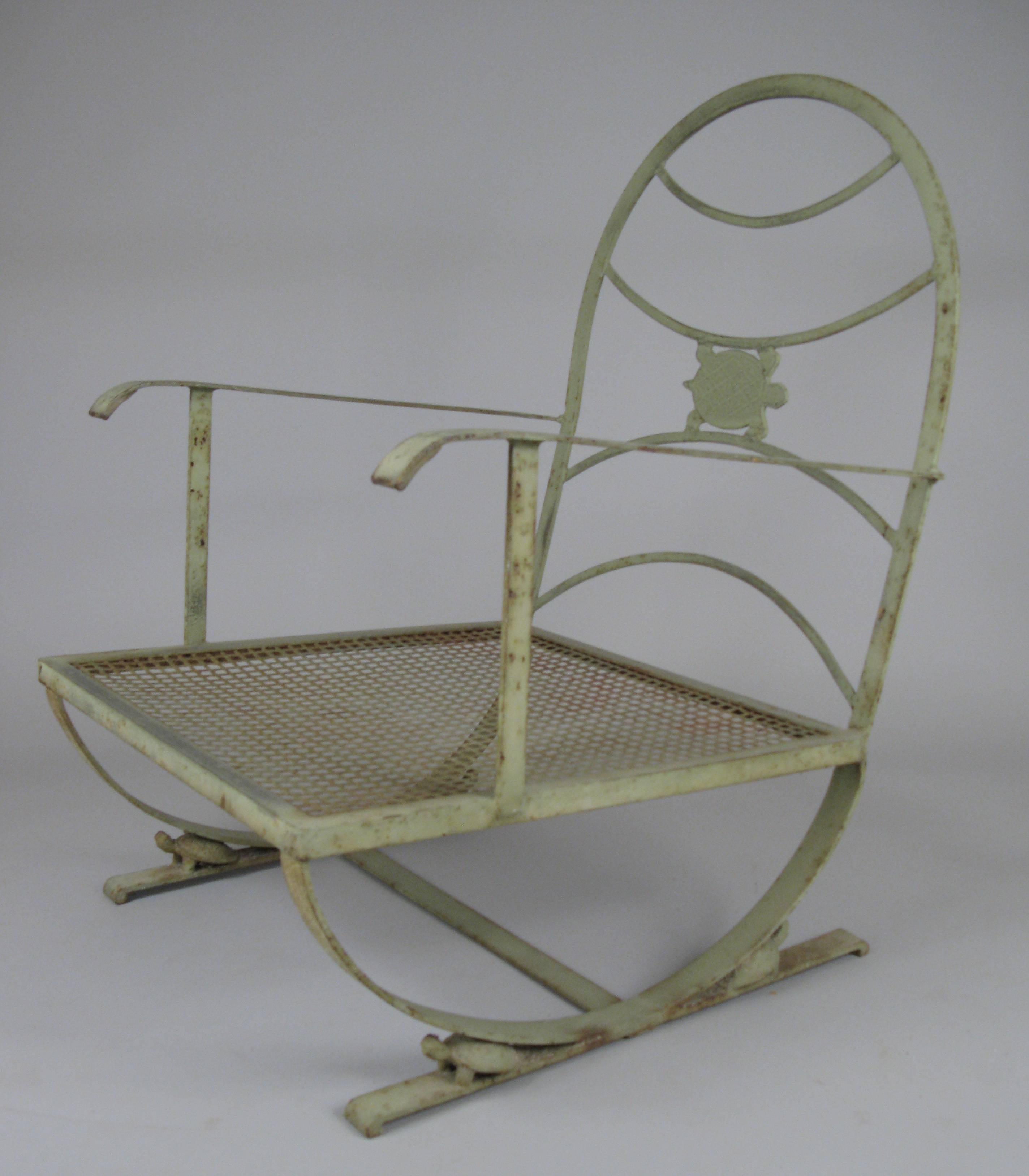 A very well made vintage wrought iron lounge chair with a turtle motif in the seatback and small turtles on the base as well. Large-scale and in its original pale green finish.