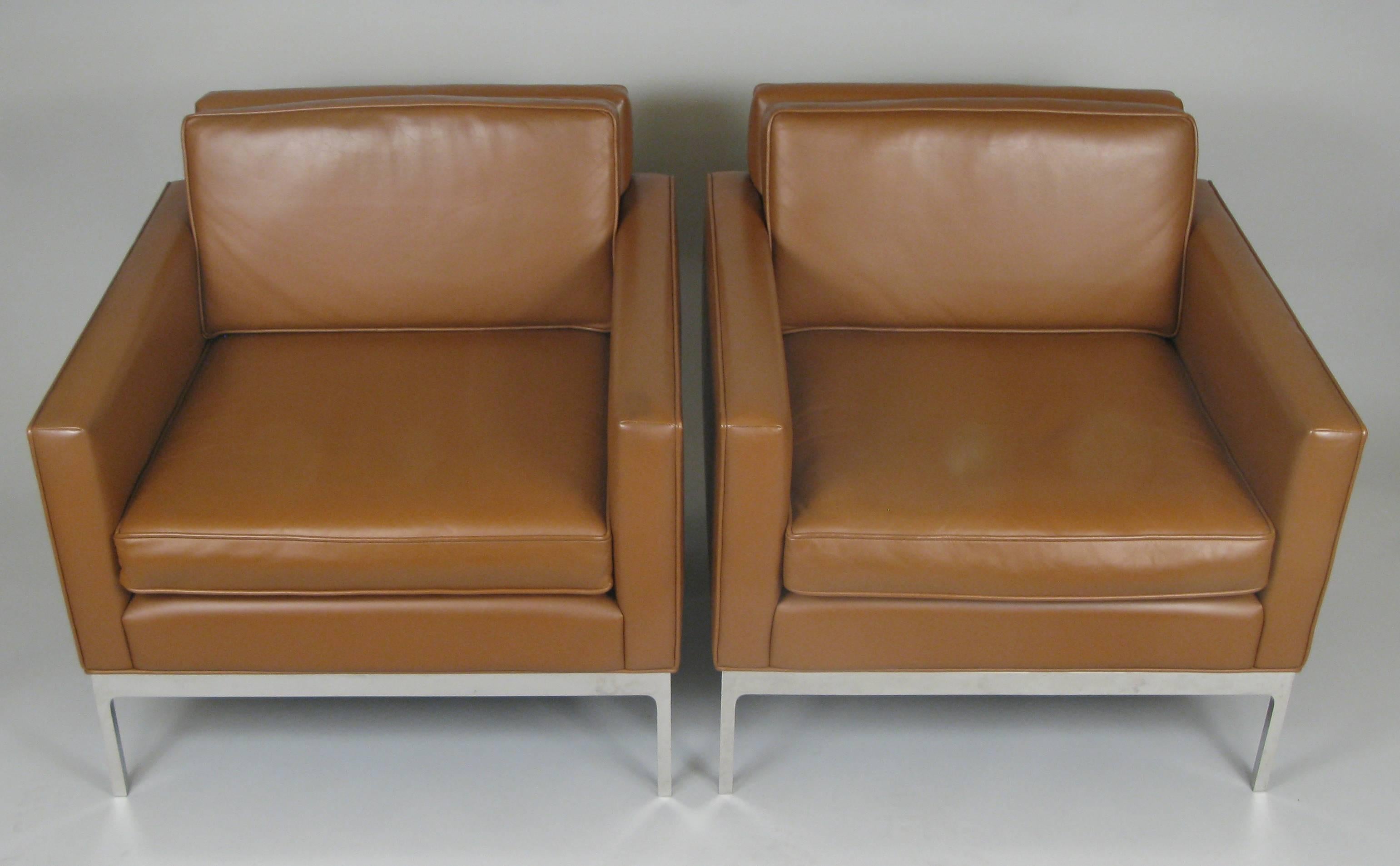 A beautiful matched pair of vintage 1970s 'Half-Arm' lounge chairs by Nicos Zographos, in their original caramel colored leather upholstery, with bases of seamless polished stainless steel. Classic and stylish, these are in excellent condition.