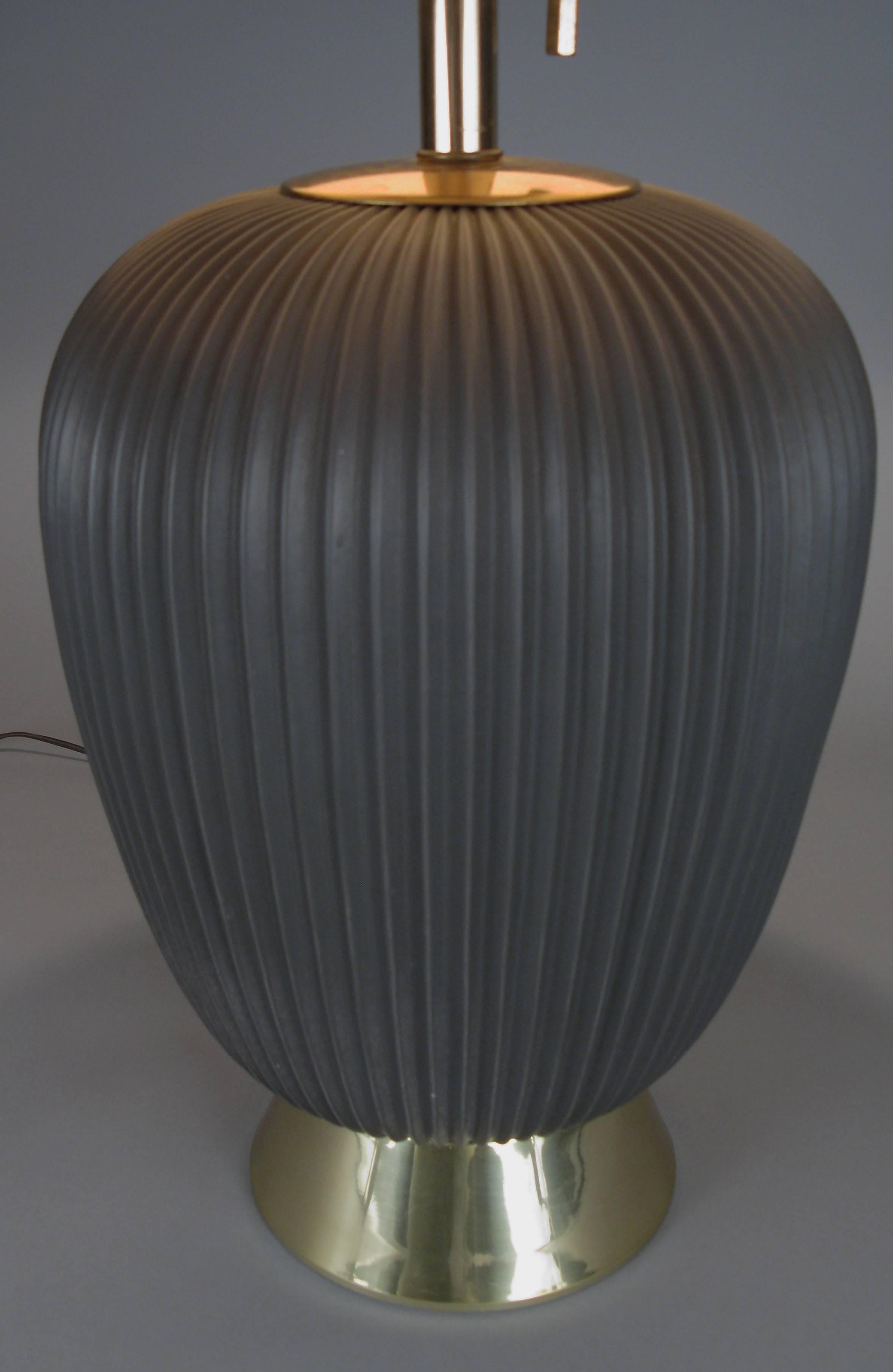 An incredible 1950s example of the rare graphite gray colored 'pleated' ceramic lamp by Gerald Thurston for Lightolier. Beautiful form mounted on a brass base. The amazing original shade mirrors the design of the lamp with a pleated surface. Fitted