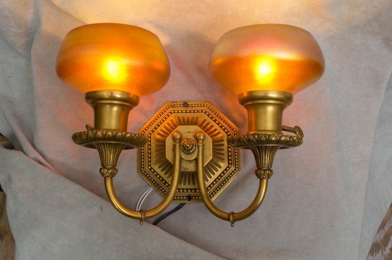 Hard to find better sconces than this beautiful pair. Finely cast metal work which is signed on the back with the Caldwell signature. Caldwell always means the highest quality in bronze work. The shades are handblown, probably by Steuben. There is