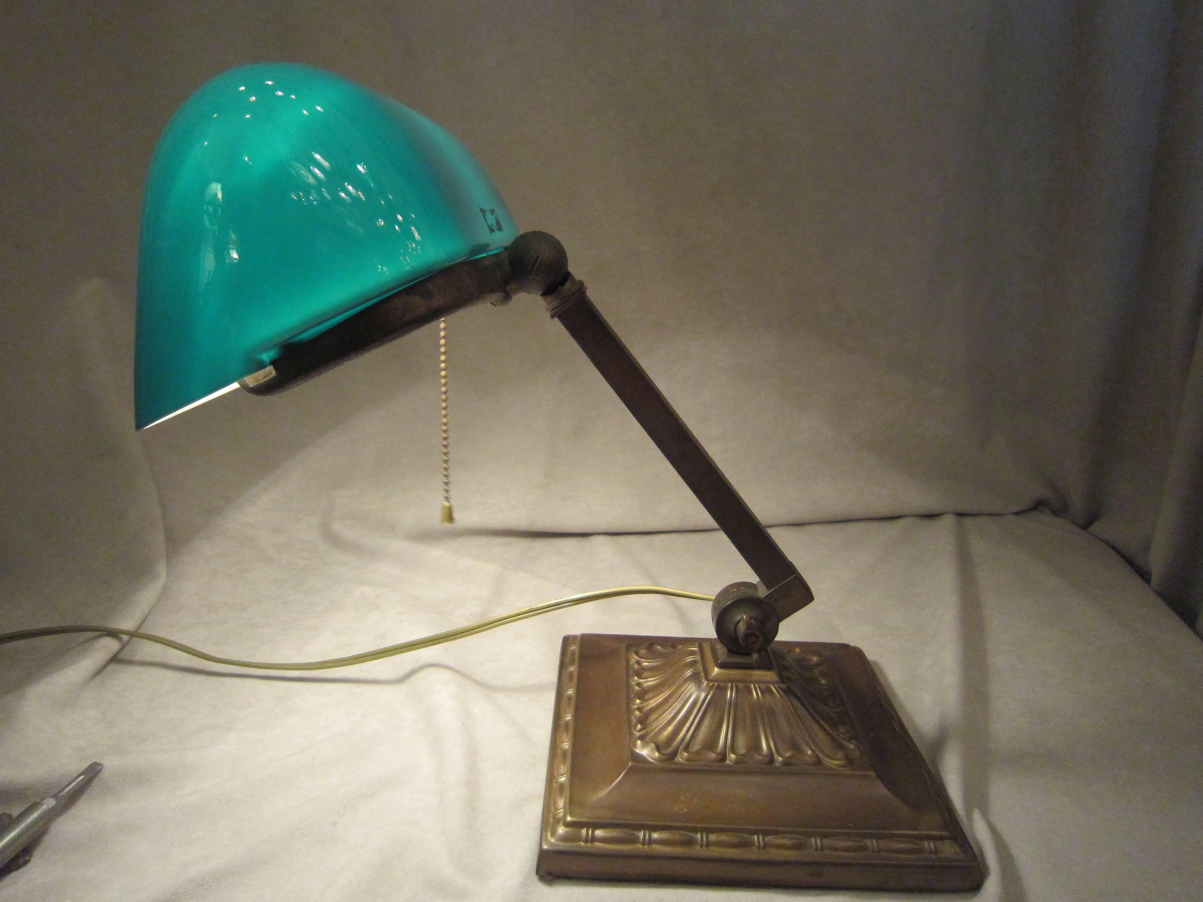 Emeralite was the premiere maker of these bankers lamps. The name signifies quality, and it has become the generic name for bankers lamps. This is a fine signed example of these desirable lamps. The angles can be adjusted in two places. There is a