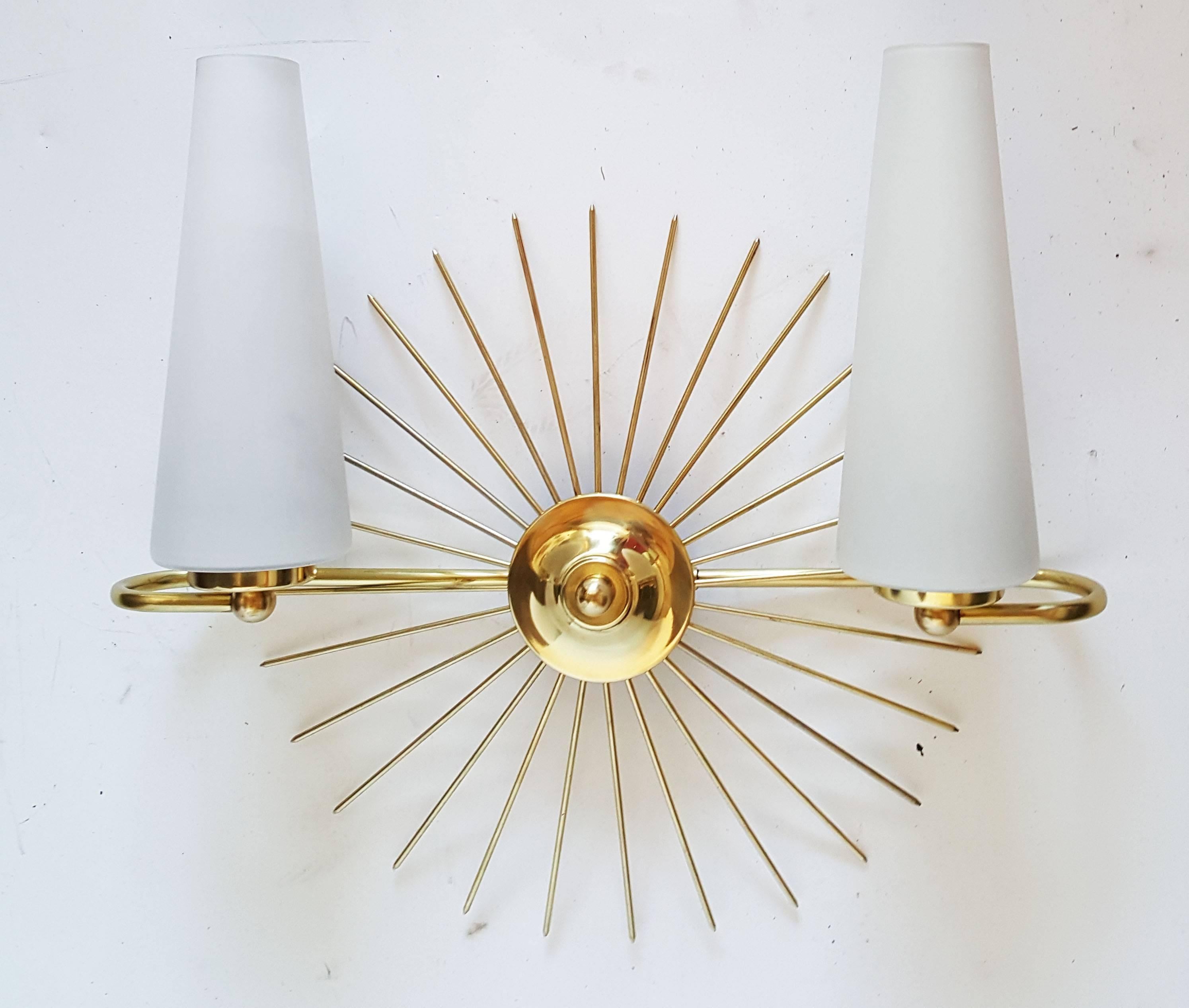 Superb pair of sun sconces by Maison Lunel, 
US rewired and in working condition 
Two bulbs, 40 watts each max
Backplate dimension: 3 inches diameter.
Have a look on our the largest collection of French and Italian Mid-Century period sconces, more