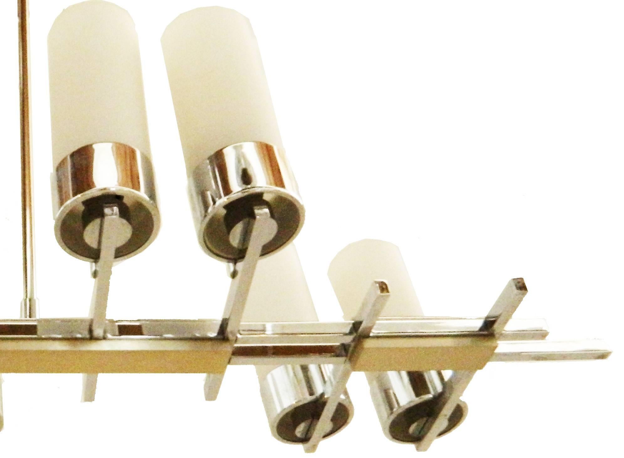 Very nice Modernist Jacques Adnet chandelier, Finished in chrome and with 8 original handmade Antique White Opaline shades.
US Rewiring and takes 8 light bulbs with max. 40 watts.
French Mid-Century Modern Light Fixture for a bright light above a