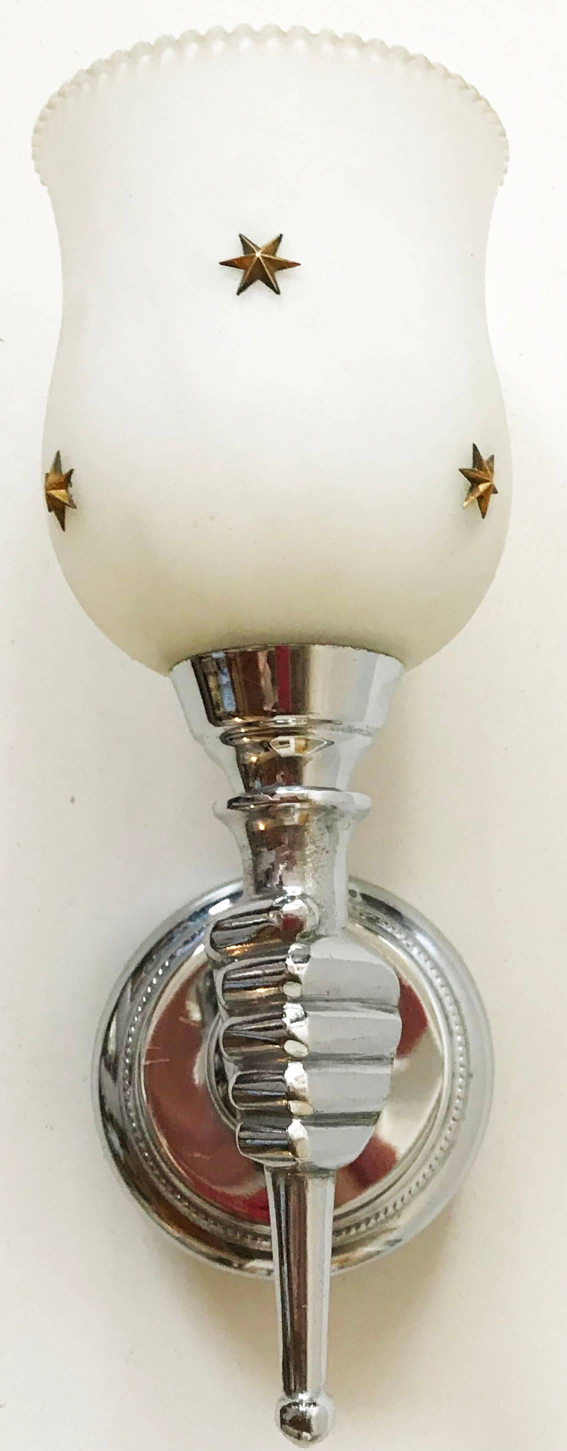 Superb pair of sconces by Andre Arbus figuring a nickel-plated hand with a opaline shade fitted with brass stars.

Measure: back plate: 3.5 inches diameter.