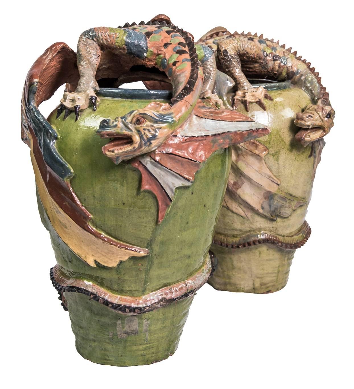 Glazed terracotta jars with dragons climbing on them in the same material. Celedon color jars and the integrated dragons are decorated in muted colors. Tonalá has been known for centuries as producing unusual and artistic pottery in clay and