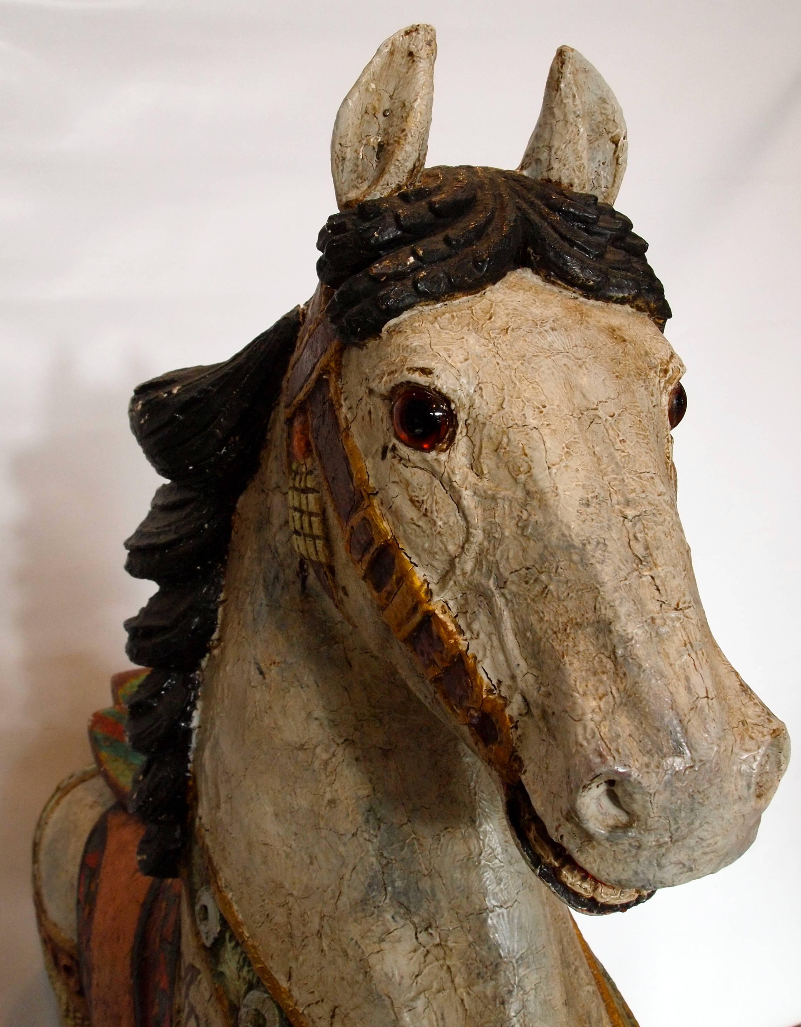 Beautifully painted and carved wood German or French carnival carousel horse 'Apache' with glass eyes and an expressive face from the late 19th to early 20th century.