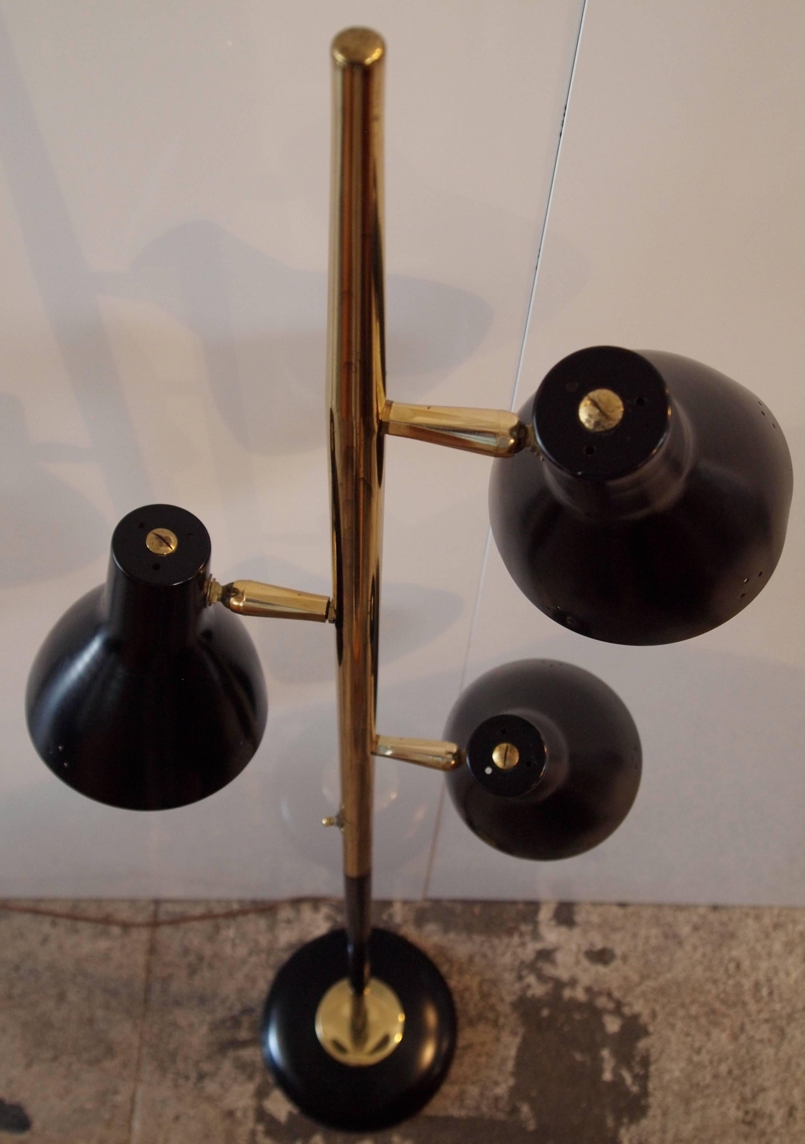 Black painted metal and brass mid-century adjustable three light floor lamp.