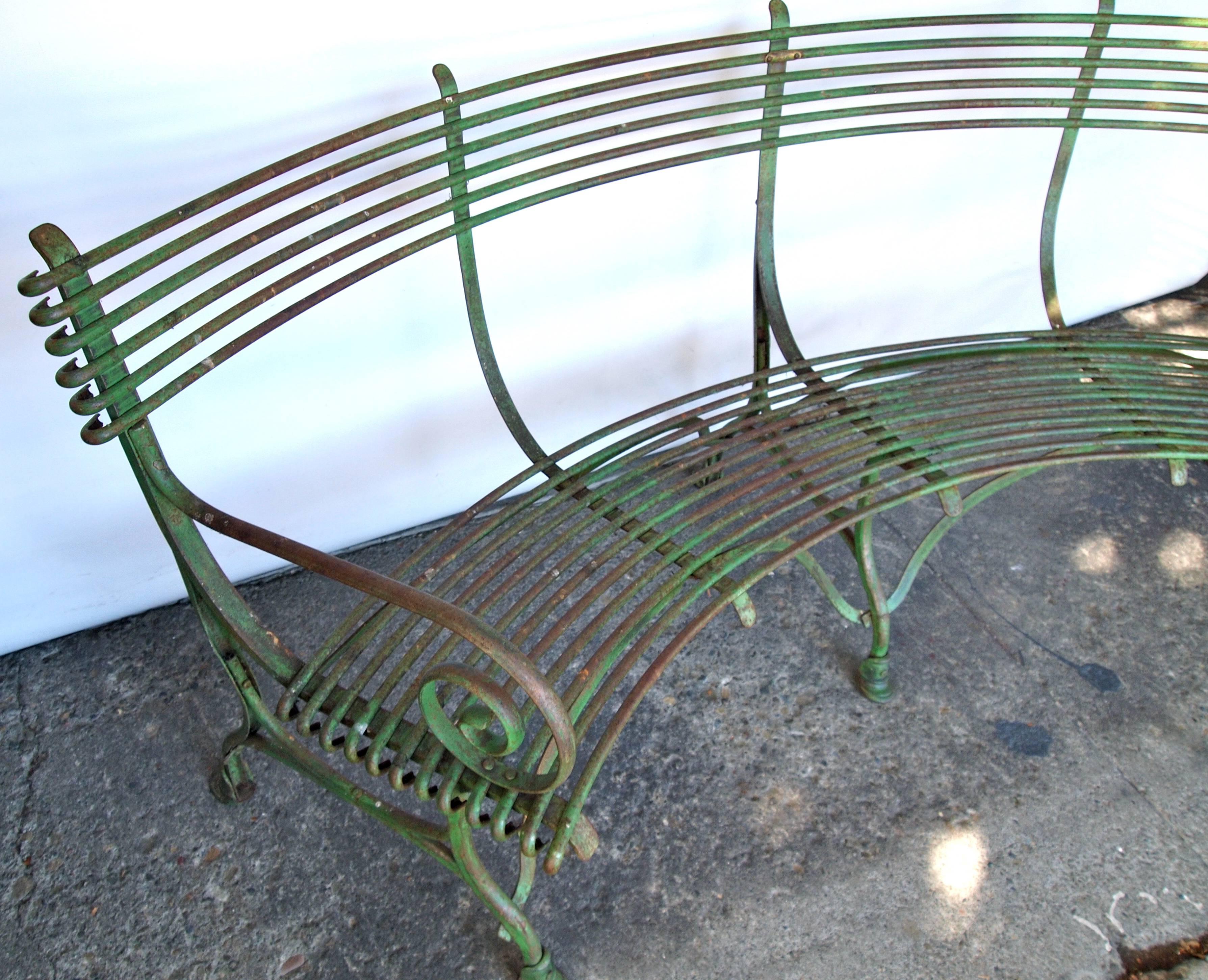 Vintage French quarter-round green painted metal garden bench.