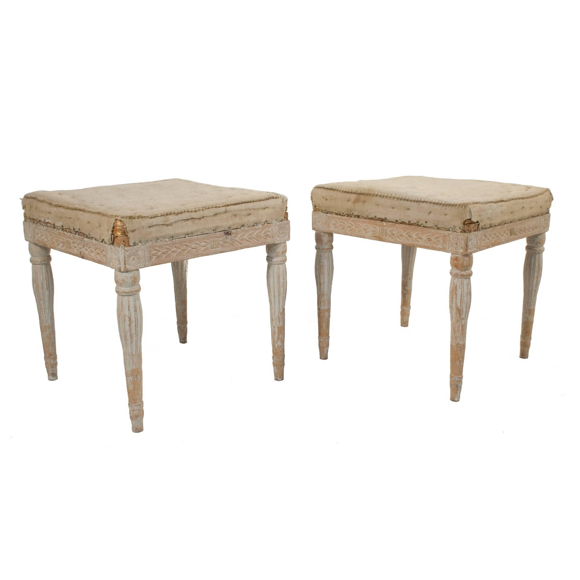 Pair of Gustavian stools in a worn pale grey patina.