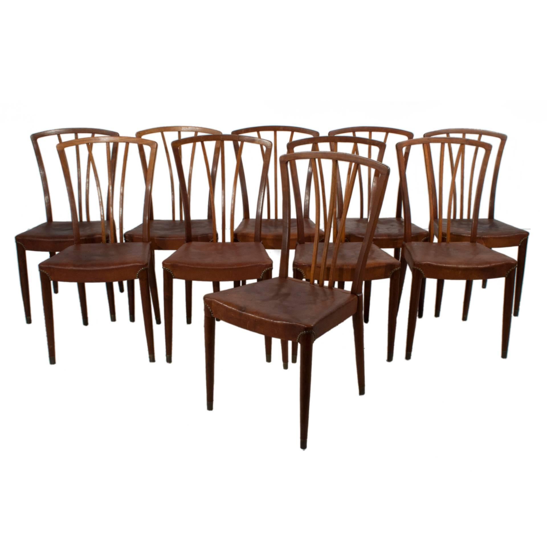 Set of ten leather and mahogany dining chairs.