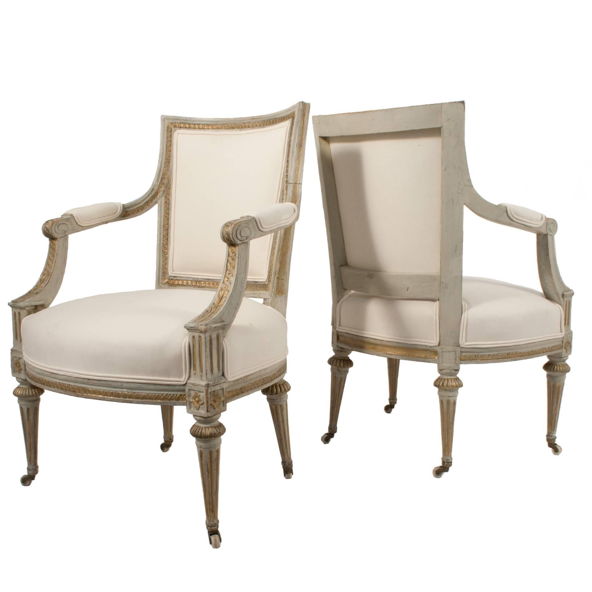 Pair of Gustavian armchairs in a worn gilded and grey patina.