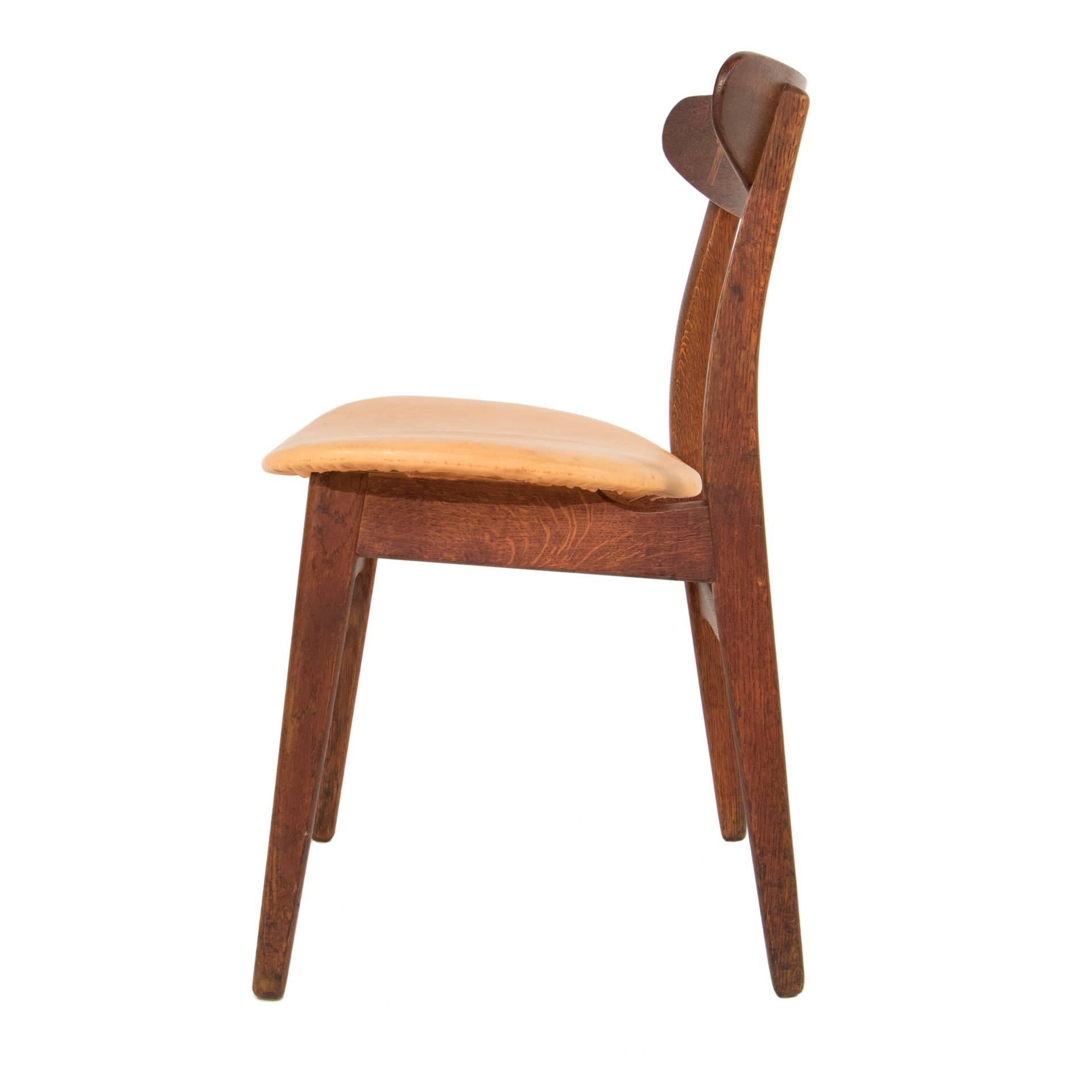 Set of eight dining chairs in teak and leather by Hans Wegner.