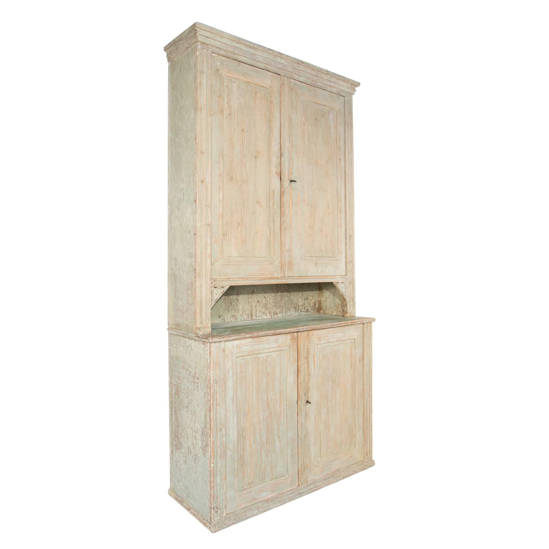 Gustavian cabinet with four doors in a worn pale green patina.